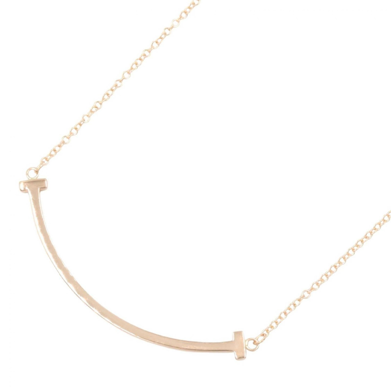 Tiffany & Co. T Smile Small Necklace, 18K Pink Gold (PG), Women's Jewelry, Tone: Tiffany & Co. T Smile Small Necklace, 18K Pink Gold (PG), Women's Jewelry, Tone A delicate 18K pink gold necklace from Tiffany & Co., featuring the iconic T Smile pendant, is up for auction. This char