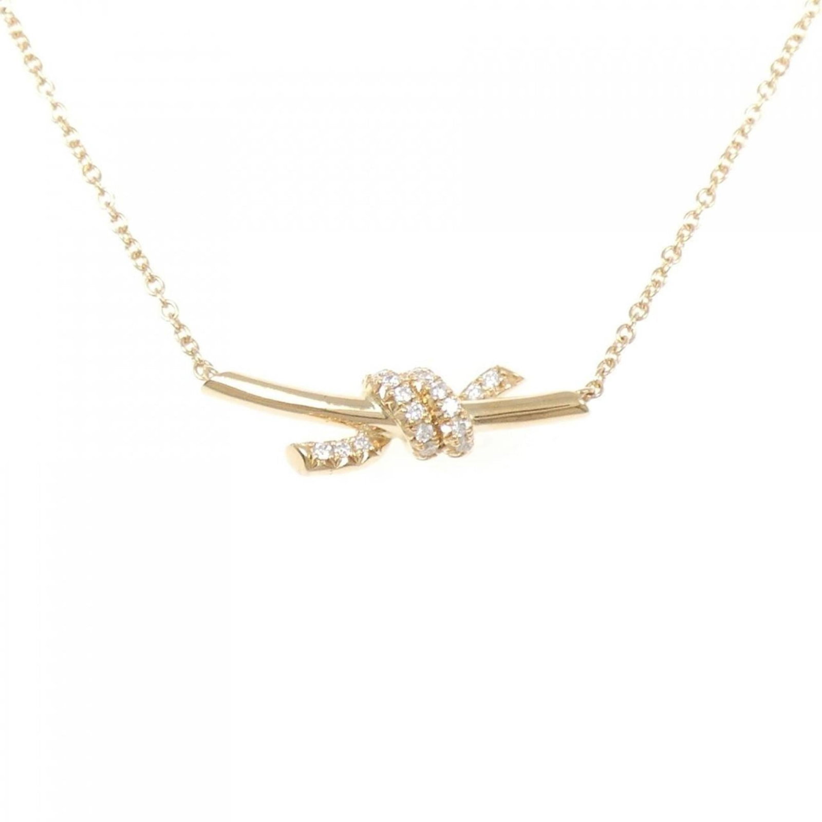 Tiffany small necklace knot.: Tiffany small necklace knot. A delicate pink gold Tiffany necklace knot pendant, featuring a 0.31'' x 0.82'' diamond set in an 8mm x 21mm design, is up for auction. This 18K pink gold piece boasts a c