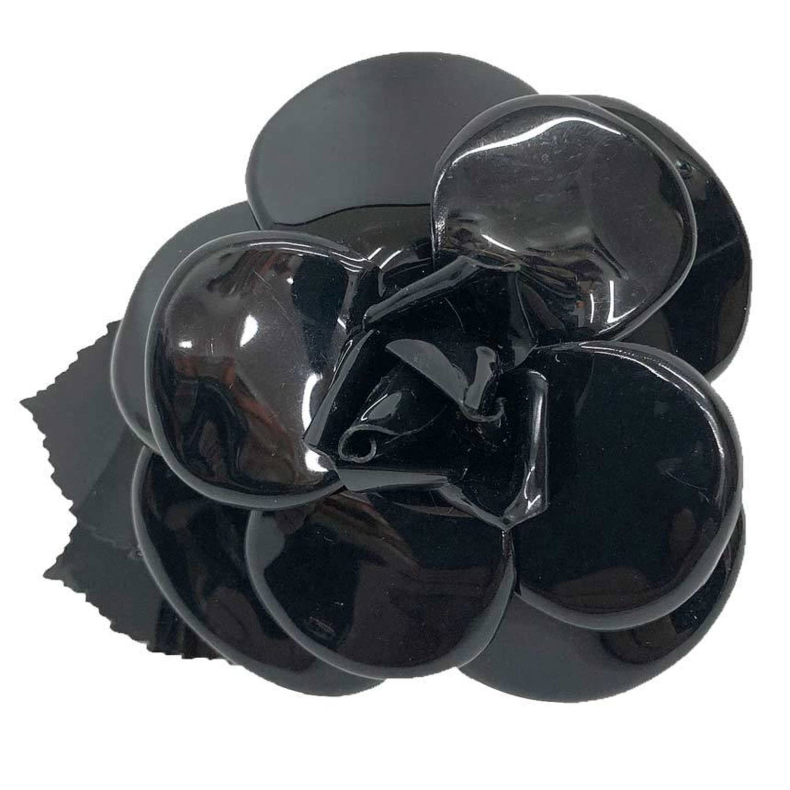 Chanel plastic corsage: Chanel plastic corsage A sleek and sophisticated black plastic corsage from Chanel, featuring a few subtle signs of wear and minor scratches. This used corsage is in very good condition, with only a