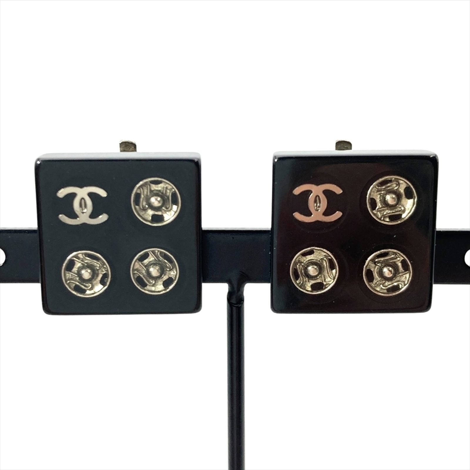 Earrings by Chanel: Earrings by Chanel Authentic Chanel clip earrings in black, featuring a timeless design with subtle signs of wear from previous use. The 16mm x 16mm size and used condition add to their vintage