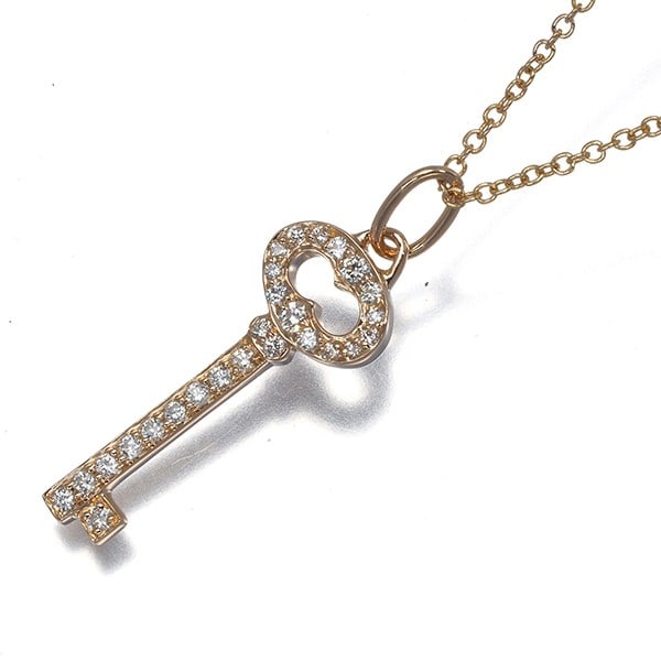 Tiffany & Co. Rose Gold Oval Key Necklace with Diamond Keys: Tiffany & Co. Rose Gold Oval Key Necklace with Diamond Keys Elevate your elegance with this stunning Tiffany & Co. Rose Gold Oval Key Necklace, featuring 18k rose gold metal and a natural diamond set
