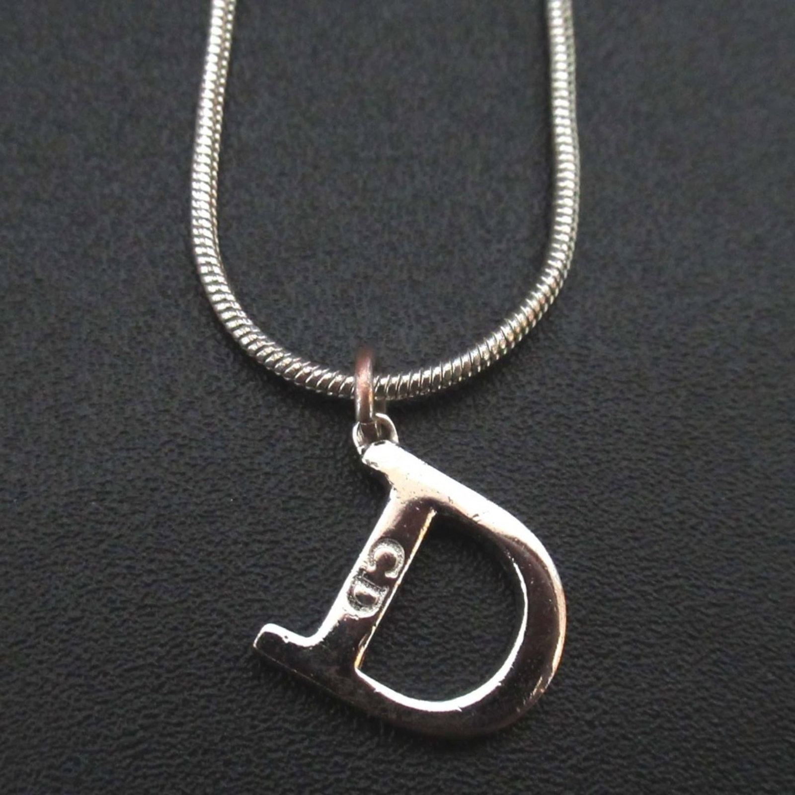 Christian Dior D logo snake chain necklace pendant silver color for women: Christian Dior D logo snake chain necklace pendant silver color for women Elevate your style with this sleek Christian Dior D logo snake chain necklace pendant in silver. Featuring the iconic Dior