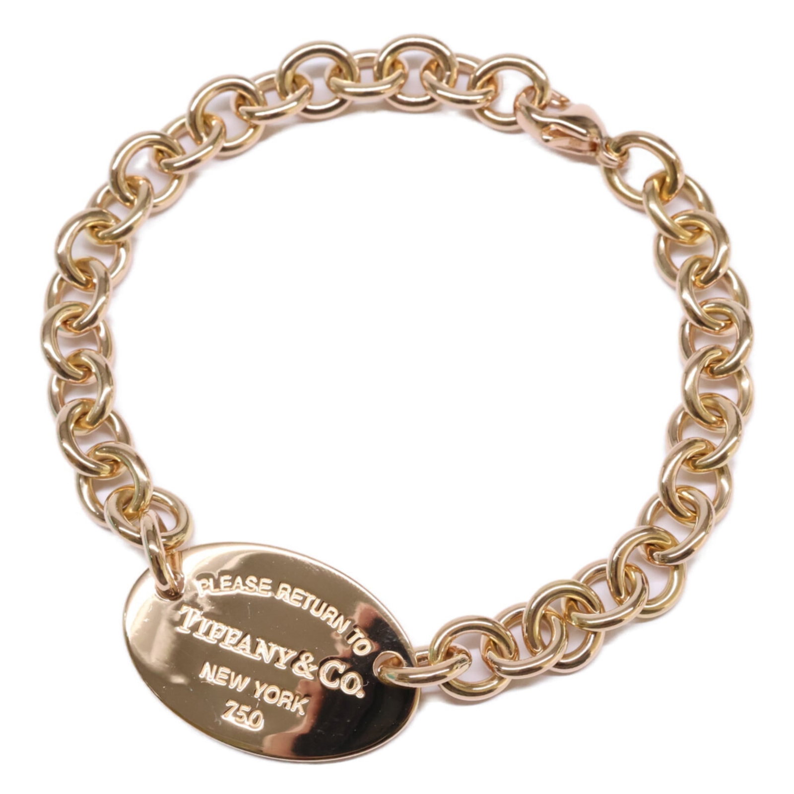 Tiffany Gold Charm Bracelet: Tiffany Gold Charm Bracelet A stunning 18K gold charm bracelet from Tiffany, this piece boasts a sleek design with a length of 20cm. In mint condition and in excellent used condition, it showcases the