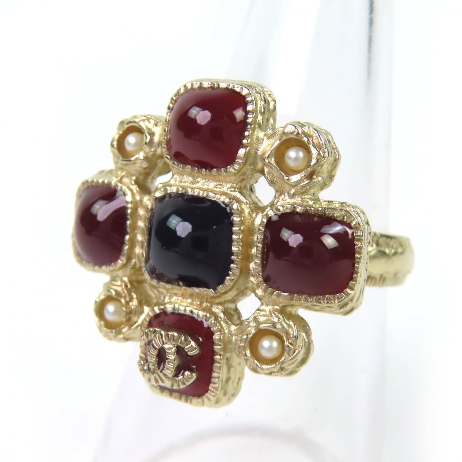 Chanel ring band: Chanel ring band A sleek and sophisticated Chanel ring band, available in black, Bordeaux, or gold, this band is a timeless accessory for any woman's jewelry collection. In excellent condition, with