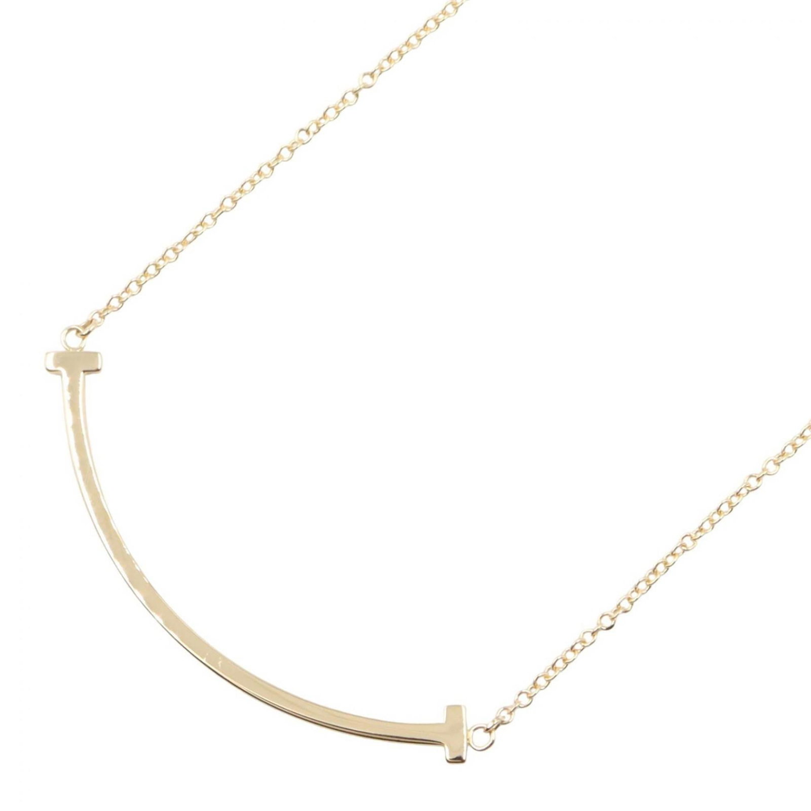 Tiffany & Co. Women's 18K Yellow Gold Small T Smile Necklace: Tiffany & Co. Women's 18K Yellow Gold Small T Smile Necklace This Tiffany & Co. necklace boasts 18K yellow gold craftsmanship, featuring a small T smile pendant that measures 3mm x 37mm. The chain is