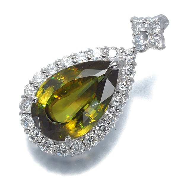900 Platinum Teardrop Diamond Pendant Sphene 6.51Ct 1.03Ct: 900 Platinum Teardrop Diamond Pendant Sphene 6.51Ct 1.03Ct A stunning 900 Platinum Teardrop Diamond Pendant showcases a unique natural Sphene stone, weighing 6.51 carats with a secondary stone of