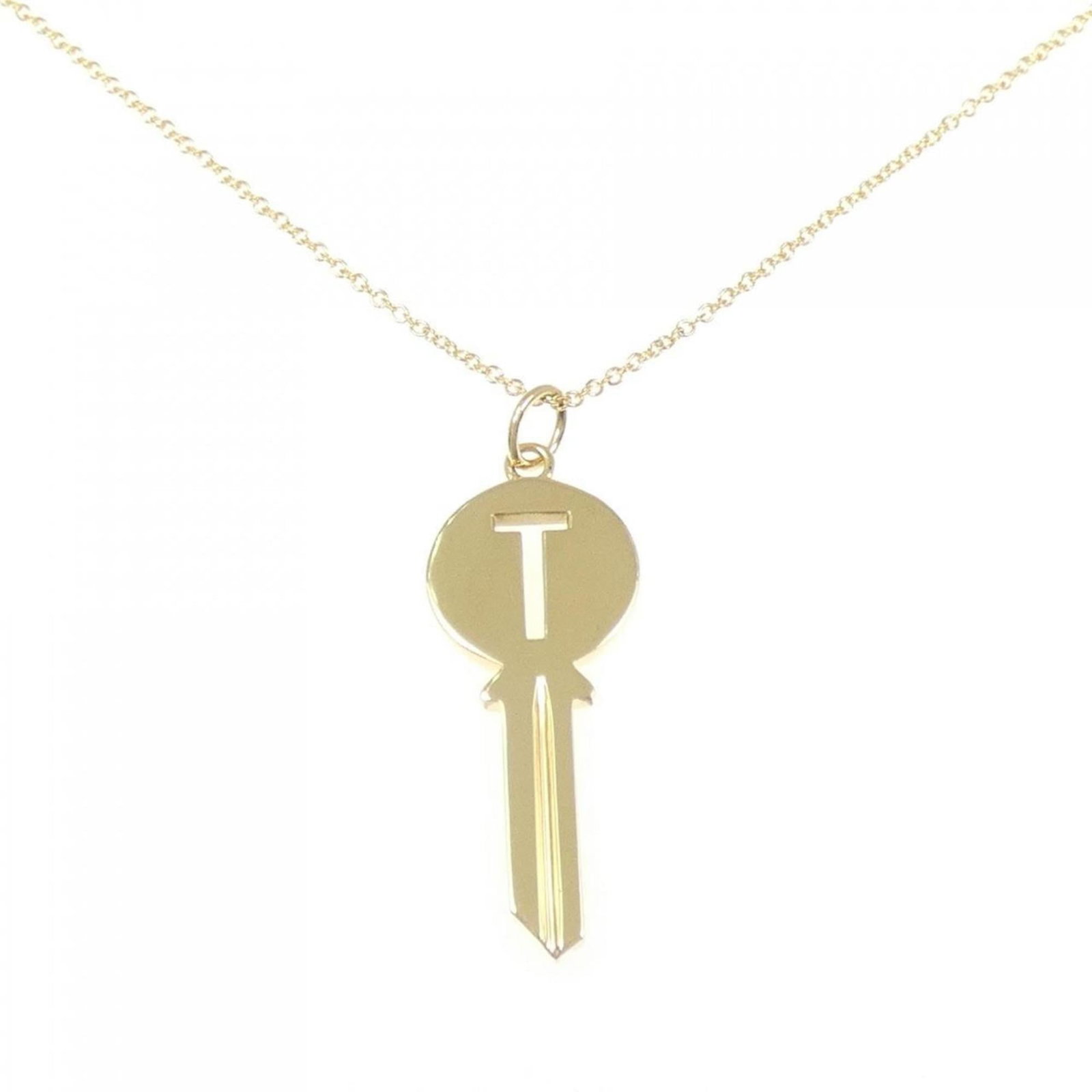 Modern key necklace by Tiffany: Modern key necklace by Tiffany A stunning 18K yellow gold Tiffany necklace showcases a modern key pendant in excellent condition. The necklace boasts a sleek design with a 32.5mm x 11.9mm pendant,