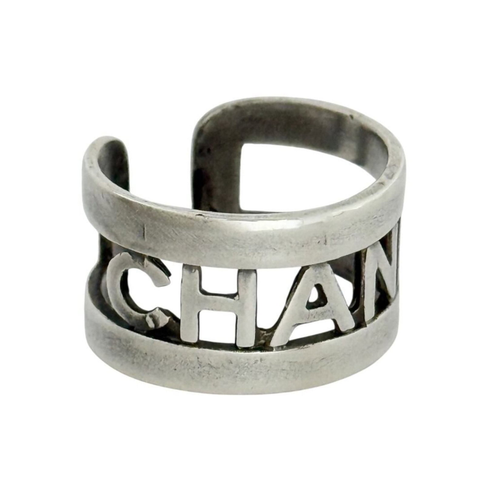 Chanel metal band ring: Chanel metal band ring A sleek and sophisticated Chanel metal band ring, this piece boasts the iconic brand's signature style with its minimalist design and metallic finish. With some subtle signs of