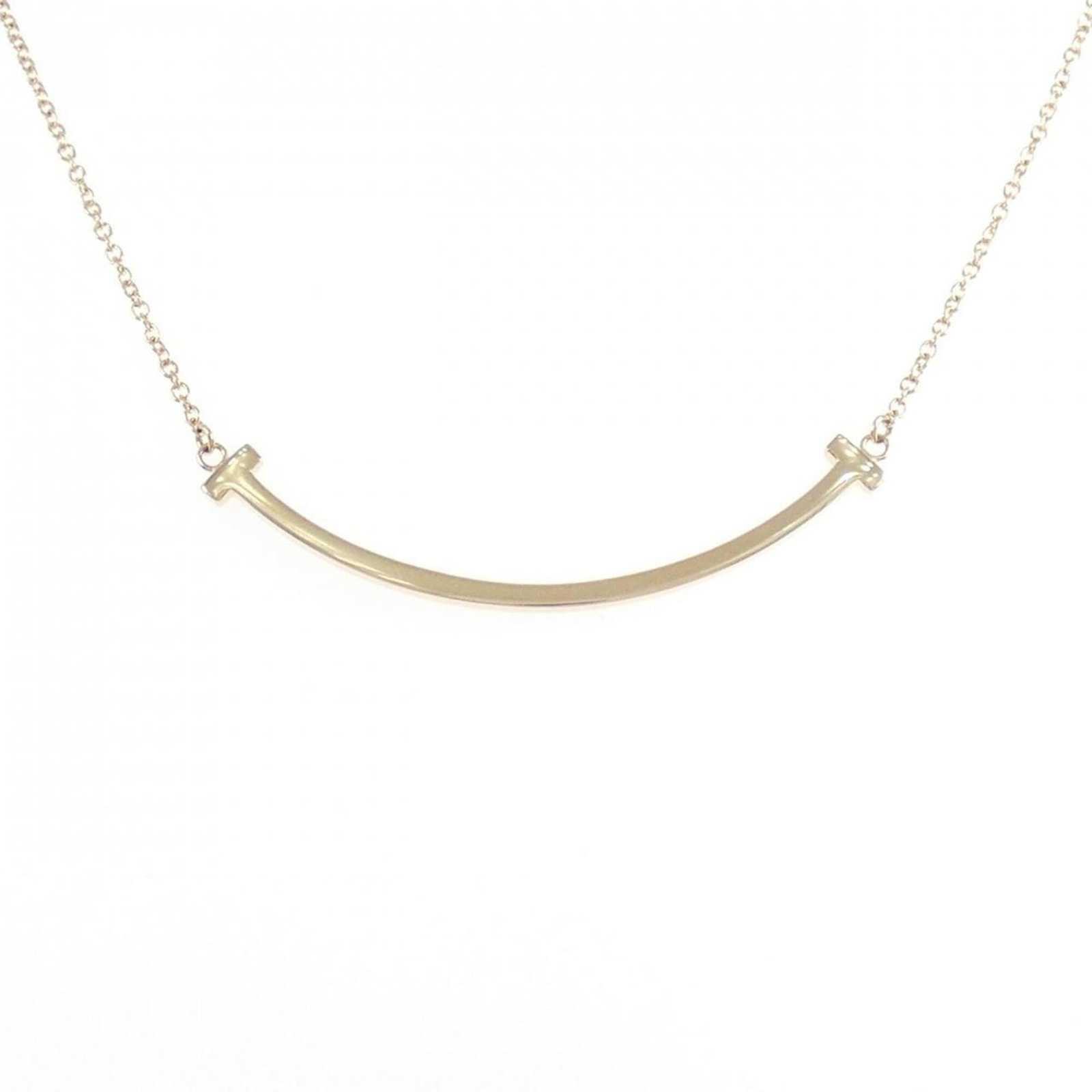 Tiffany small necklace with a smile: Tiffany small necklace with a smile A delicate pink gold necklace from Tiffany & Co., featuring a small pendant with a charming smile. This 18K pink gold piece is crafted to perfection, with a