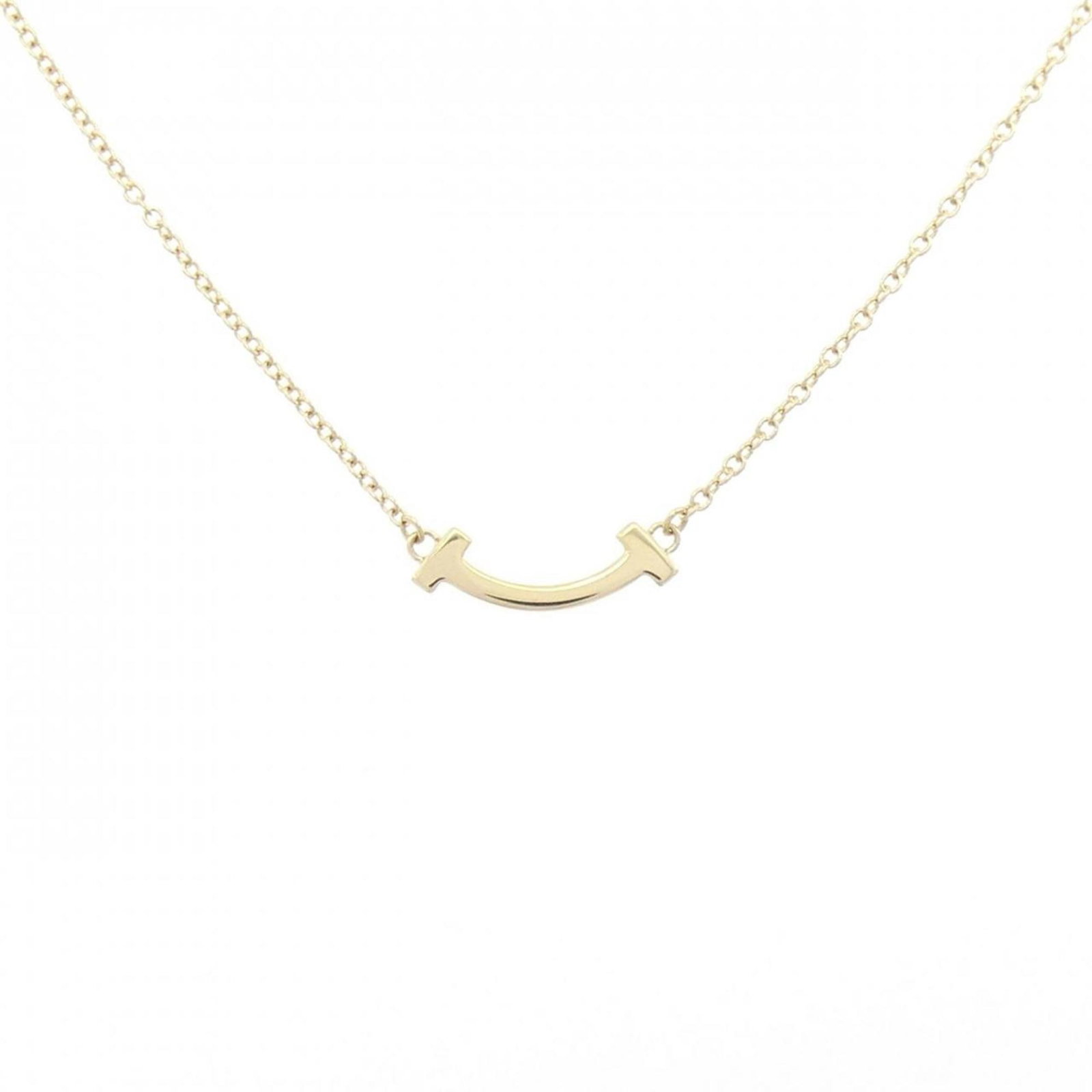 Tiffany T Smile Mini Necklace: Tiffany T Smile Mini Necklace A delicate and elegant Tiffany T Smile Mini Necklace in 18K yellow gold, featuring a small pendant with a subtle smile design. This versatile necklace is adjustable to
