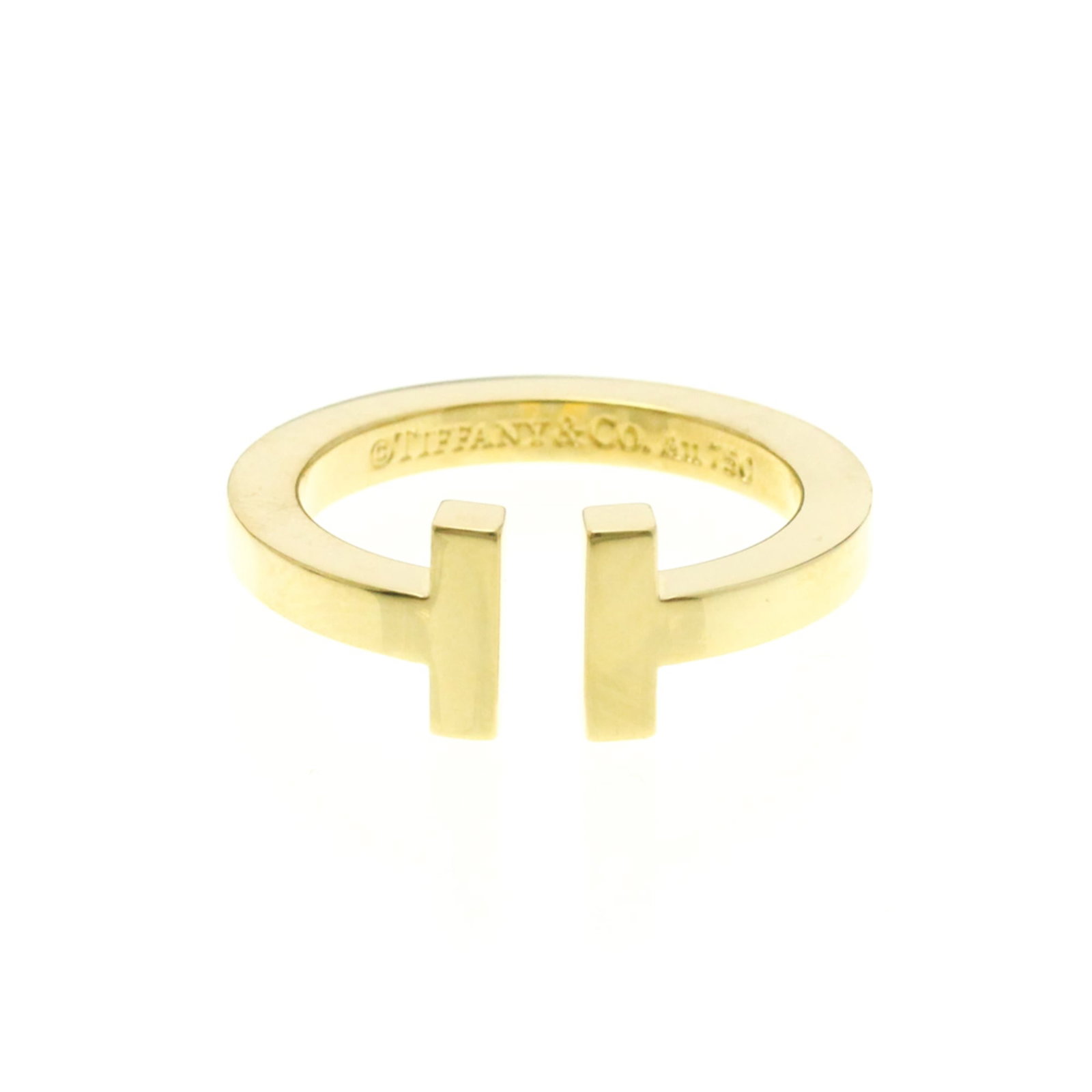 Tiffany 18k yellow gold band ring: Tiffany 18k yellow gold band ring A delicate 18k yellow gold band ring from Tiffany, featuring a sleek design with a subtle width of 2.4mm. This fashion-forward piece is crafted from high-quality