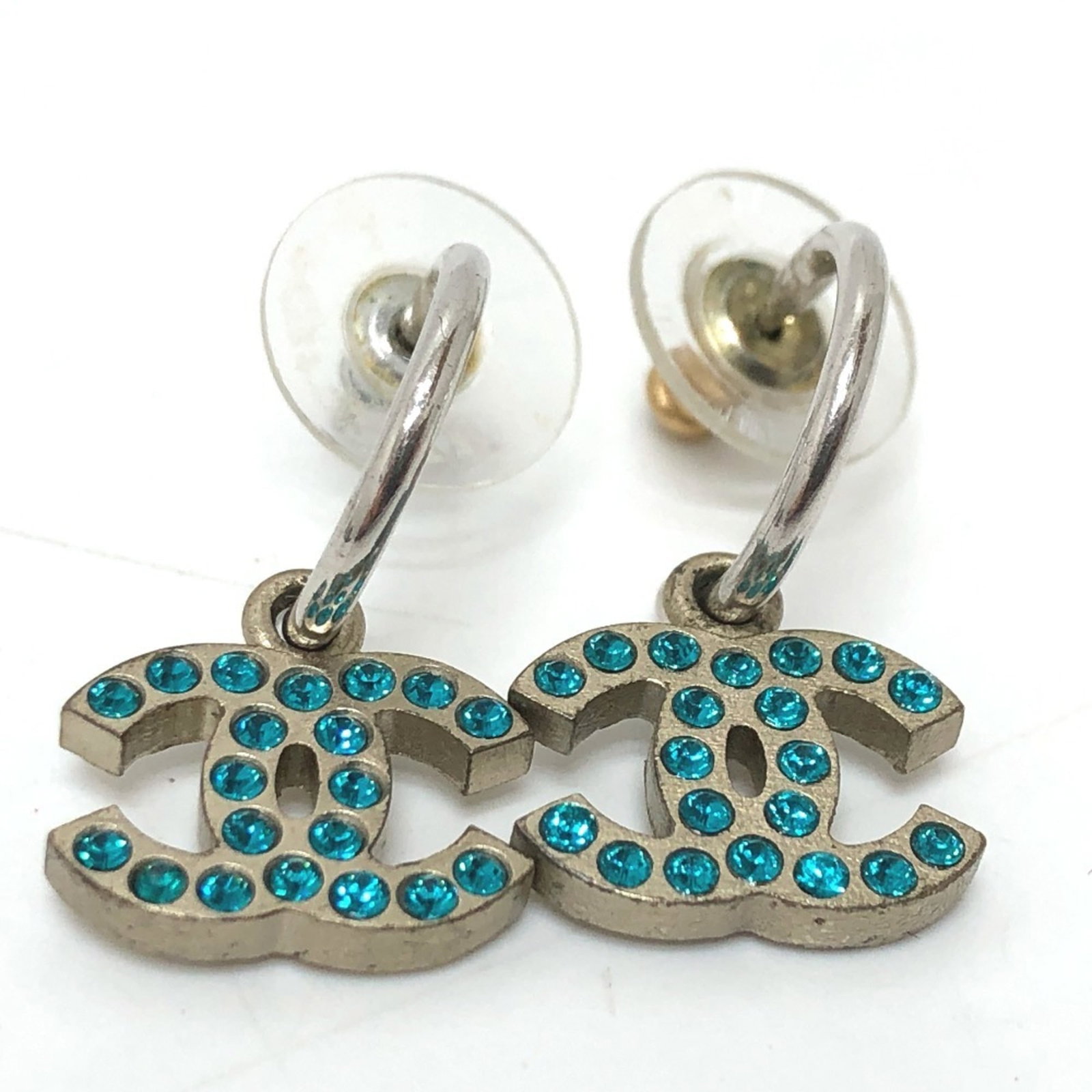 Chanel metal stud earrings: Chanel metal stud earrings Elevate your everyday style with these silver Chanel metal stud earrings, featuring the iconic brand's signature design. With a subtle 25mm x 15mm size and a sleek, modern