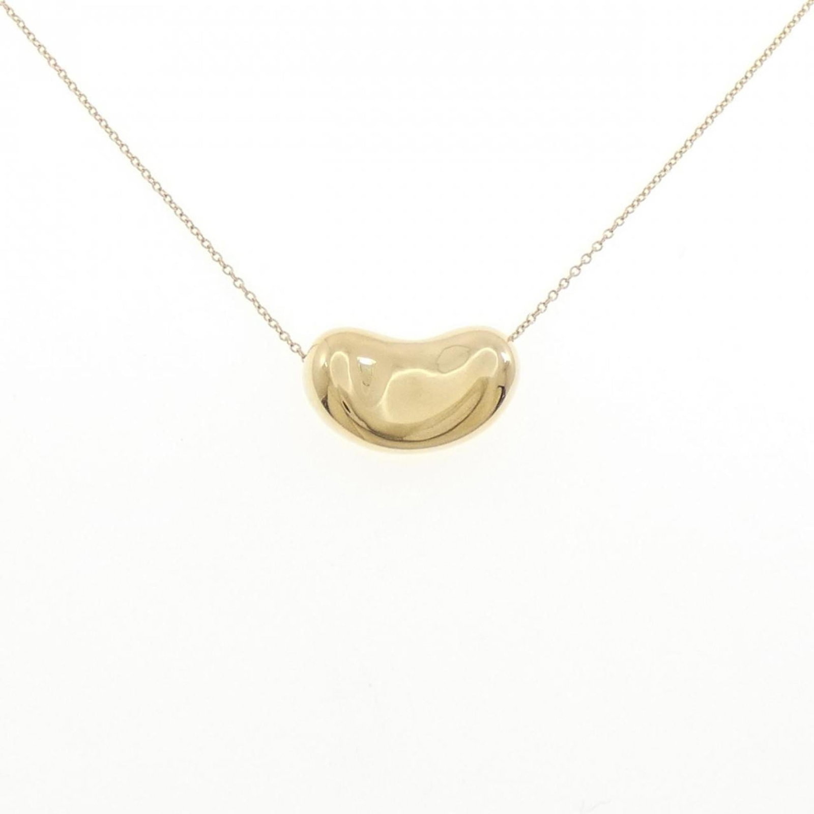 Tiffany Beans Necklace: Tiffany Beans Necklace A stunning 18K yellow gold Tiffany Beans necklace pendant adorns this beautiful piece of jewelry. The pendant measures 12.5mm x 20.5mm and is set against a chain with a 44 cm
