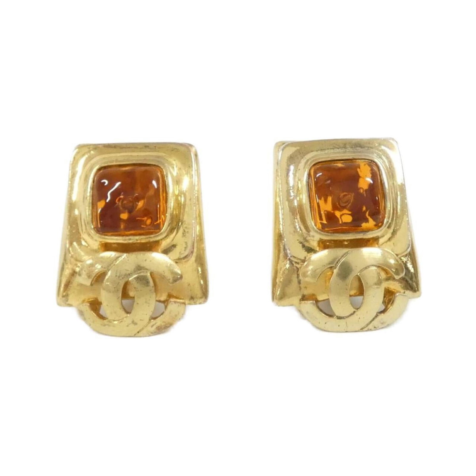 Earrings by Chanel: Earrings by Chanel Authentic Chanel clip earrings in vibrant orange, featuring a sleek and modern design. With a few signs of wear, these earrings still shine with their bold color and timeless style.