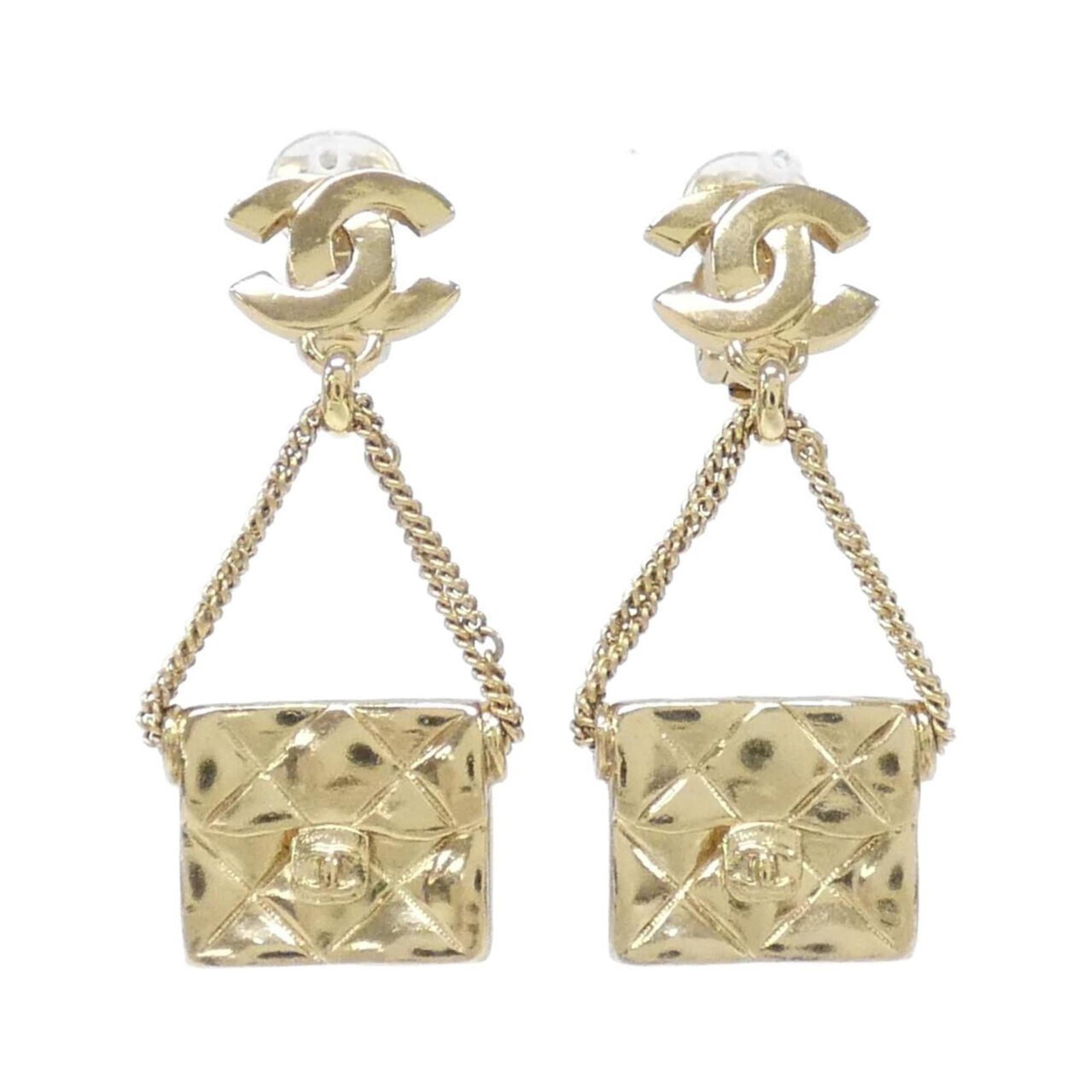 Earrings by Chanel: Earrings by Chanel Elegant gold clip earrings from Chanel, featuring a classic design with subtle scratches and minor wear. In very good condition, these earrings showcase the timeless style of the