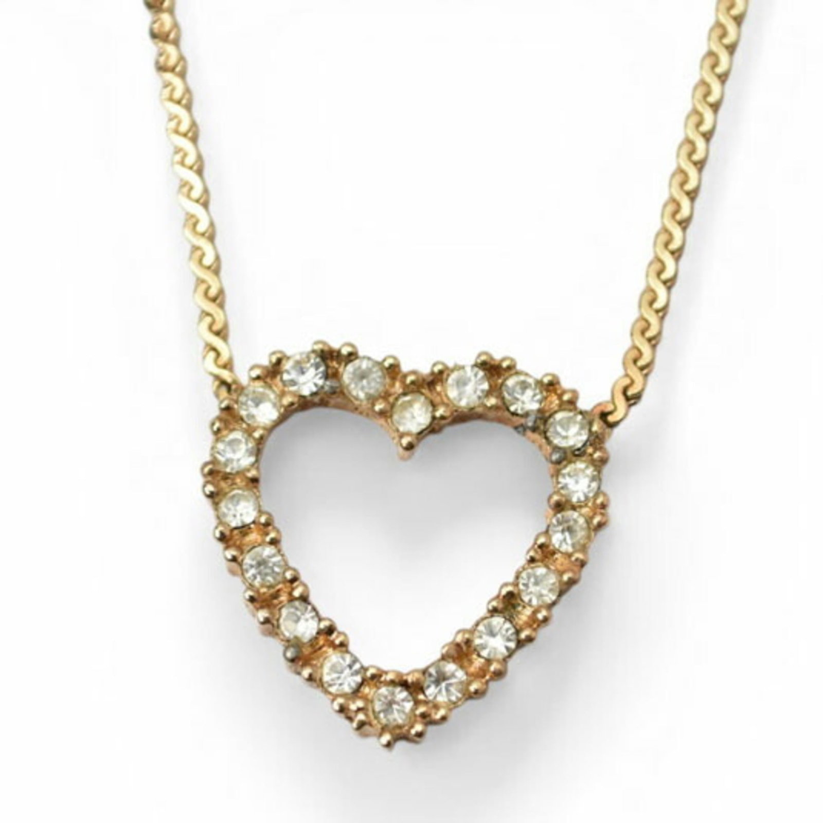 Christian Dior necklace with gold and rhinestone heart motif pendant.: Christian Dior necklace with gold and rhinestone heart motif pendant. Elegant and eye-catching, this Christian Dior necklace boasts a stunning gold and rhinestone heart motif pendant that adds a