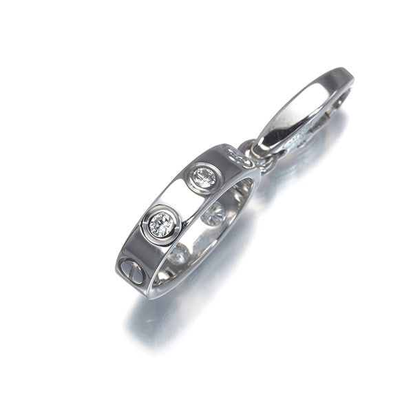 Cartier 18k white gold diamond pendant love charm.: Cartier 18k white gold diamond pendant love charm. A delicate Cartier 18k white gold diamond pendant charm, crafted in France with natural diamonds, adds a touch of elegance to any outfit. The 18k whi