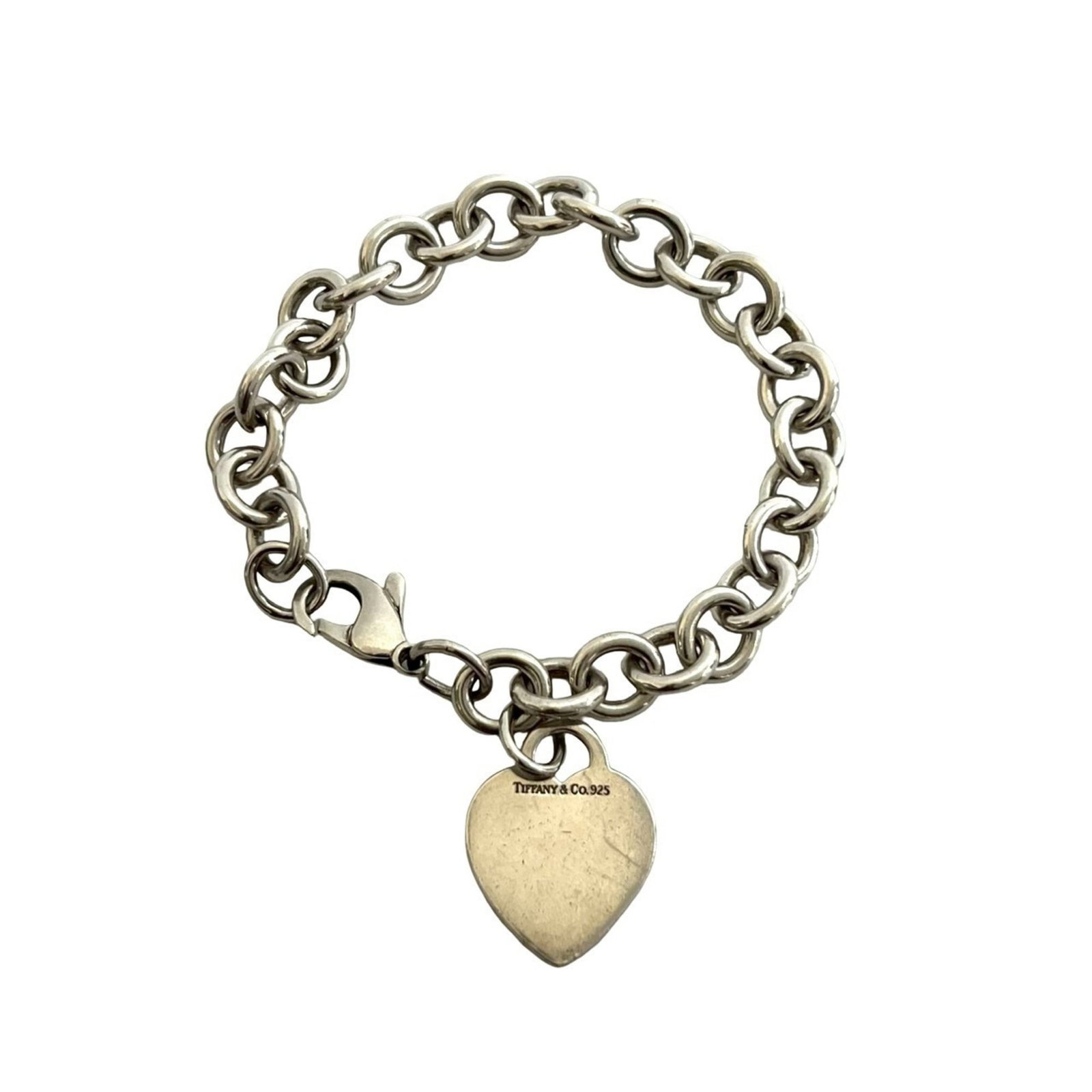 Tiffany Charm Bracelet Silver 925: Tiffany Charm Bracelet Silver 925 A delicate 20cm silver charm bracelet from Tiffany, crafted with sterling silver (925). This used piece shows signs of gentle wear and minor scratches, giving it a