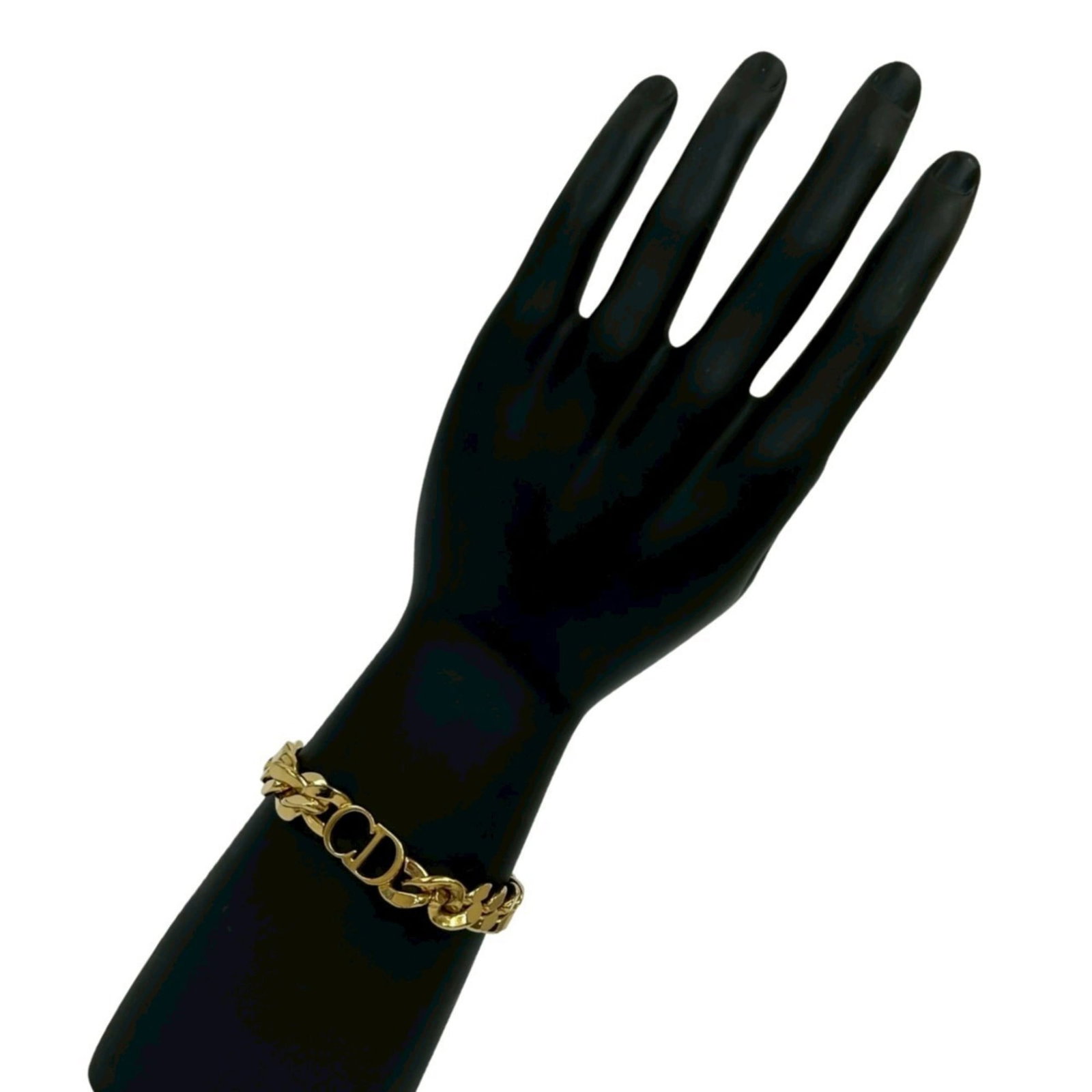 Christian Dior Gold Charm Bracelet: Christian Dior Gold Charm Bracelet A delicate Christian Dior charm bracelet in gold plating, featuring a classic design that adds a touch of elegance to any outfit. With its 22cm length and subtle sig