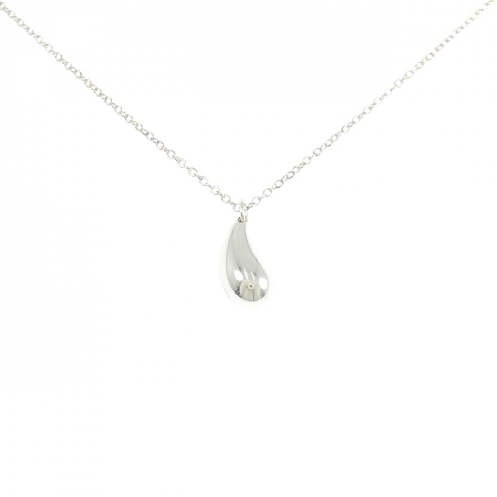 Tiffany teardrop Necklace: Tiffany teardrop Necklace A delicate Tiffany teardrop necklace in sterling silver 925, featuring a 14mm x 6mm pendant with subtle scratches and minor dirt marks. The necklace falls comfortably around