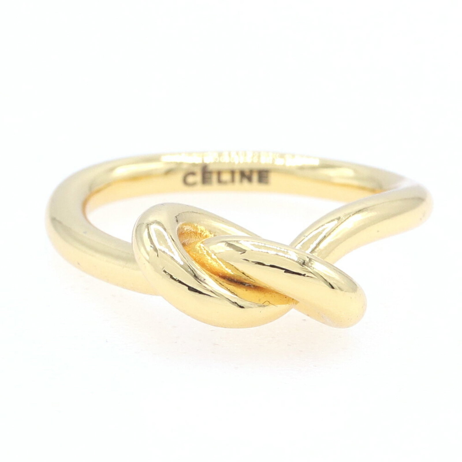 Celine is a metal band ring.: Celine is a metal band ring. A gold metal band ring from Celine, with a slender 2.5mm width and a weight of 3.8g, adds a touch of elegance to any outfit. This used ring has some minor scratches and