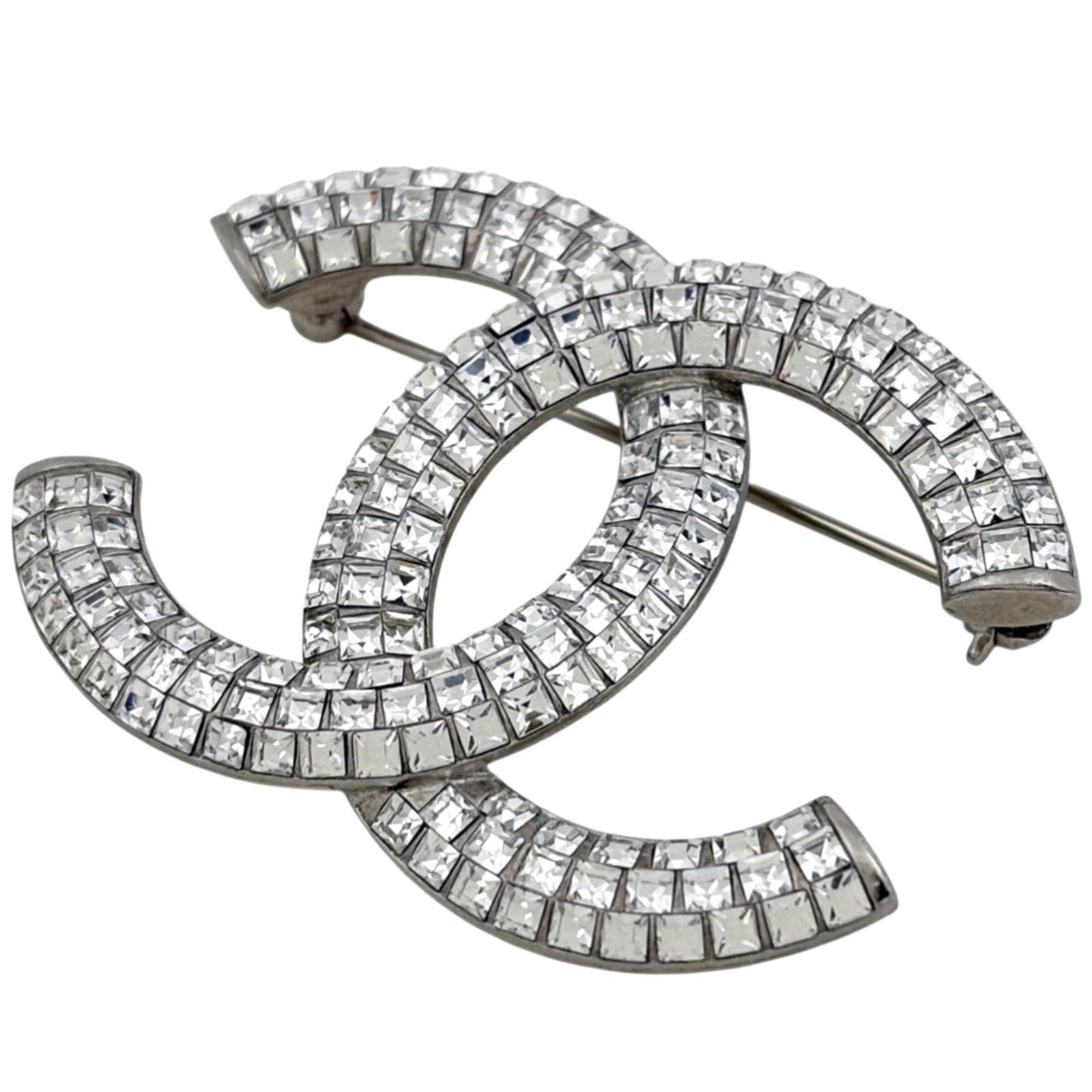 Chanel metal brooch: Chanel metal brooch A sleek and sophisticated silver Chanel metal brooch, this elegant accessory adds a touch of timeless glamour to any outfit. With its understated yet refined design, it makes a