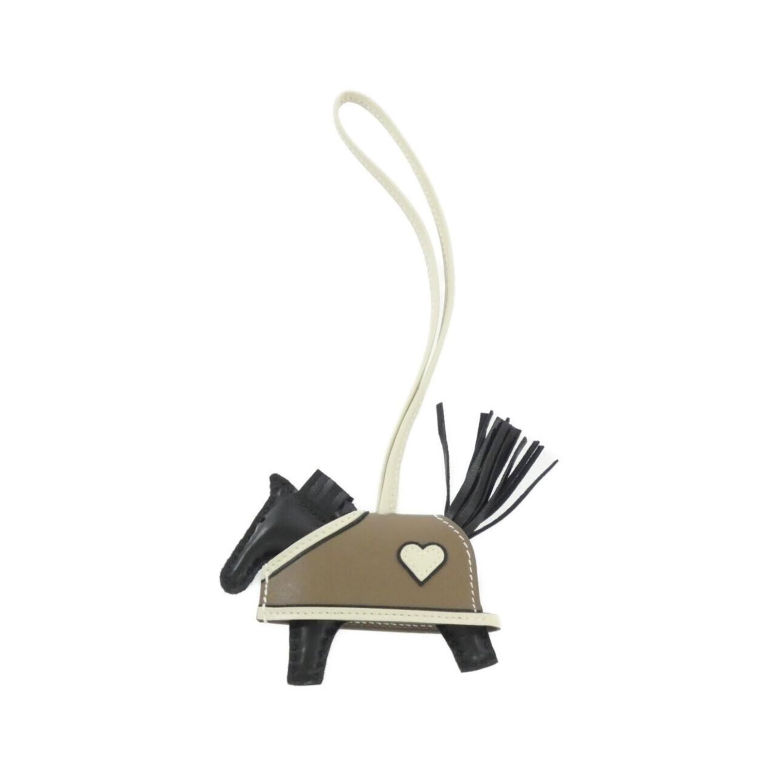 Hermes Handbag Charm Agneau Milo, Swift Leather: Hermes Handbag Charm Agneau Milo, Swift Leather A sleek and sophisticated accessory for your handbag, this Hermes Agneau Milo charm is crafted from high-quality Swift Leather and features a timeless