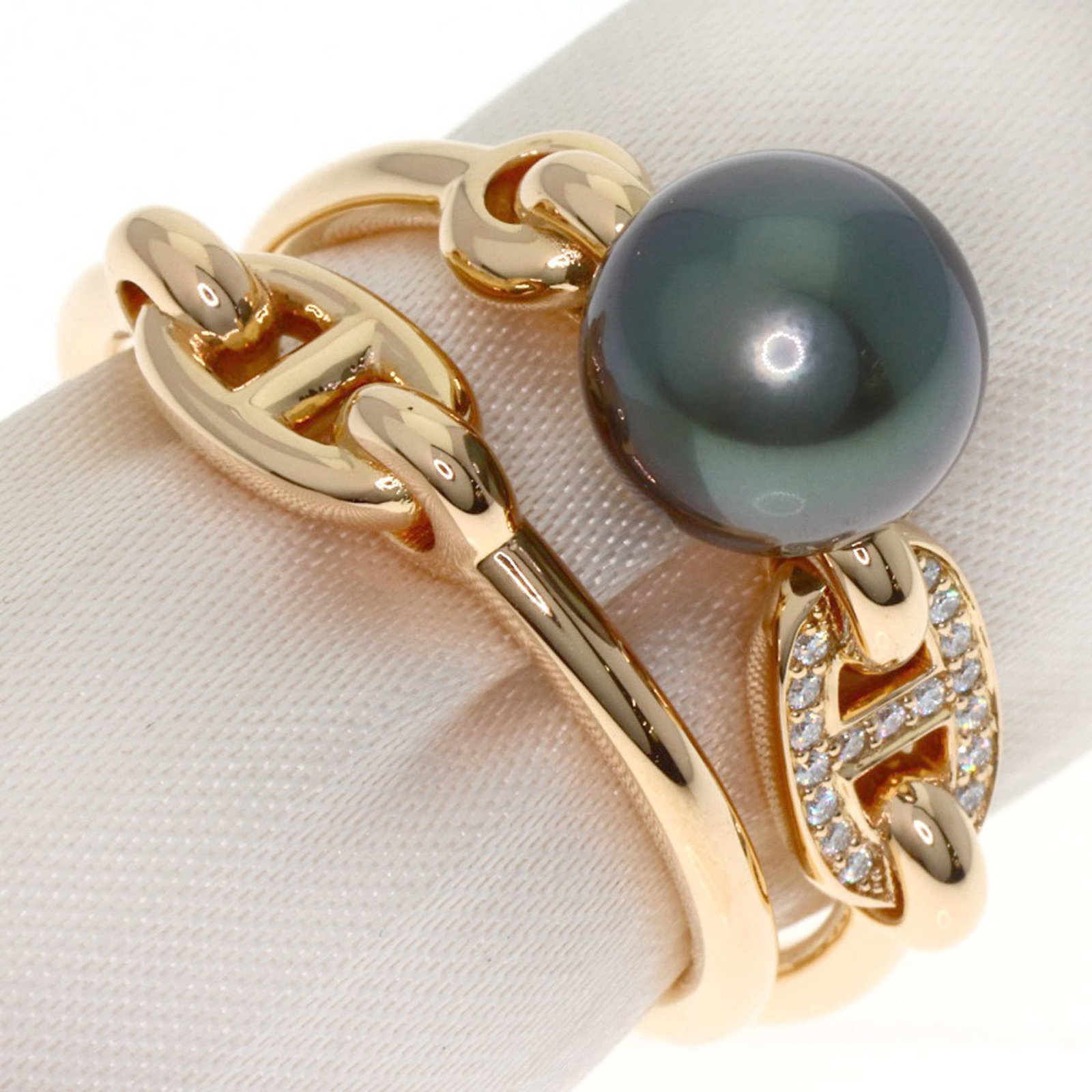 Pink Gold 18K Hermes Ring Band: Pink Gold 18K Hermes Ring Band A delicate 18K pink gold ring band from the iconic French fashion house Hermes, featuring a striking black pearl and diamond combination that adds subtle elegance to any