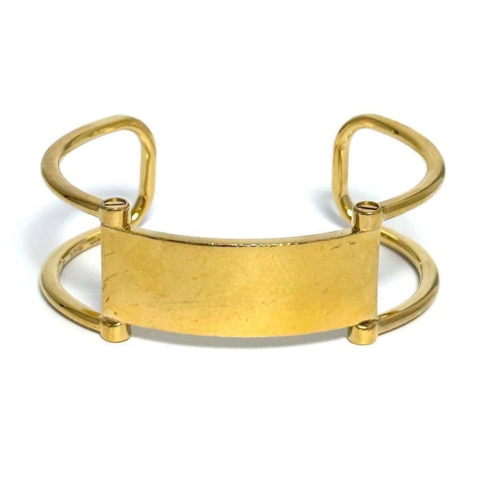 Celine is a metal bangle.: Celine is a metal bangle. A sleek metal bangle from Celine, measuring 16cm in length, adds a touch of sophistication to any outfit with its understated design. This used bangle shows signs of wear,
