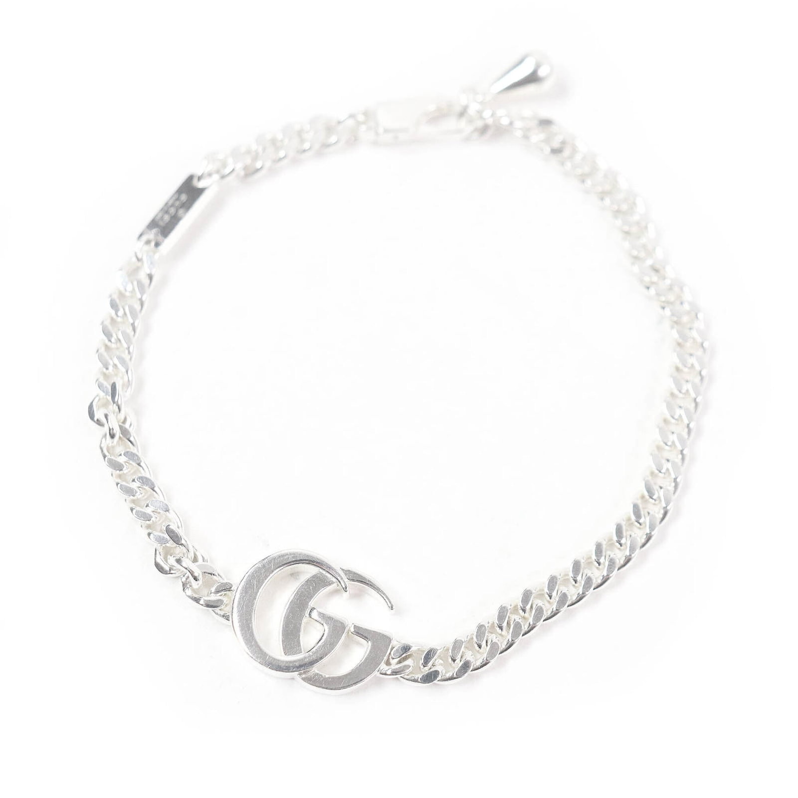 Gucci is a silver charm bracelet: Gucci is a silver charm bracelet A sleek and sophisticated silver charm bracelet from Gucci, featuring a classic design with subtle scratches and minor wear that add to its vintage charm. Made from
