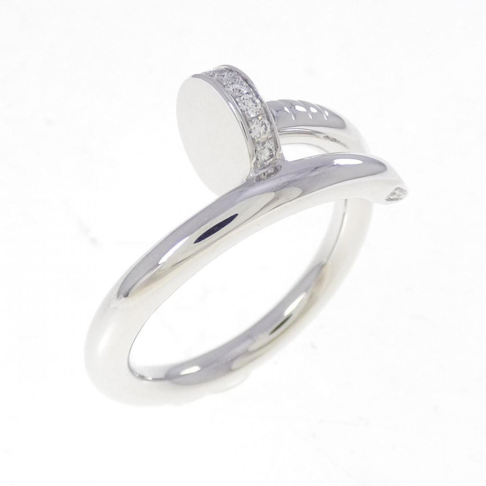 Cartier white gold ring band: Cartier white gold ring band A Cartier white gold ring band with 18K material and diamond stones adds a touch of luxury to any outfit. This pre-owned piece boasts a classic design, featuring a few sub