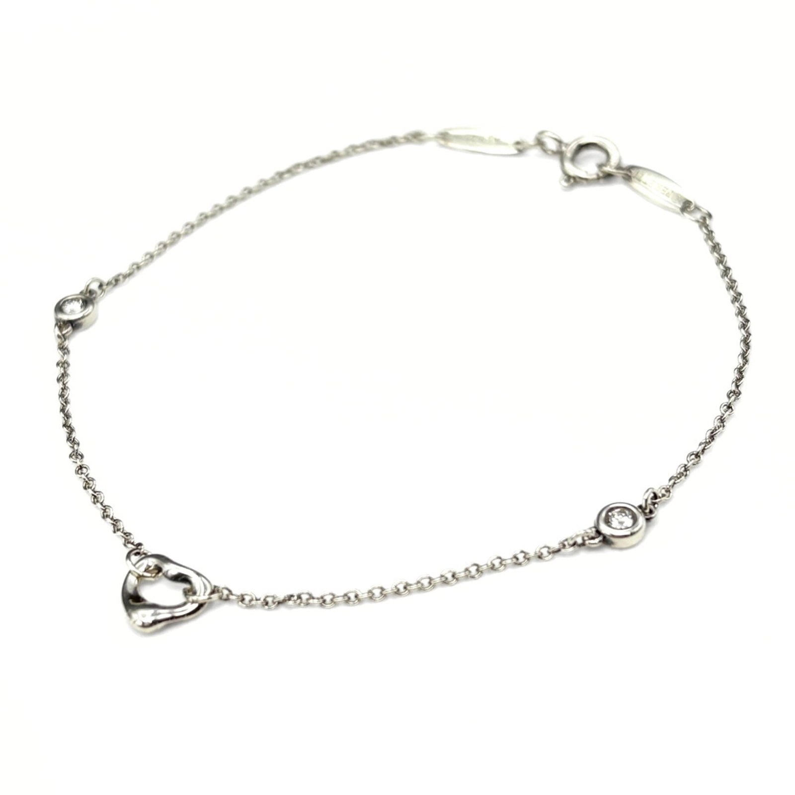 Tiffany silver charm bracelet.: Tiffany silver charm bracelet. A delicate Tiffany silver charm bracelet, crafted with intricate attention to detail, boasts a 7.08" length and is made from sterling silver. With its classic design and