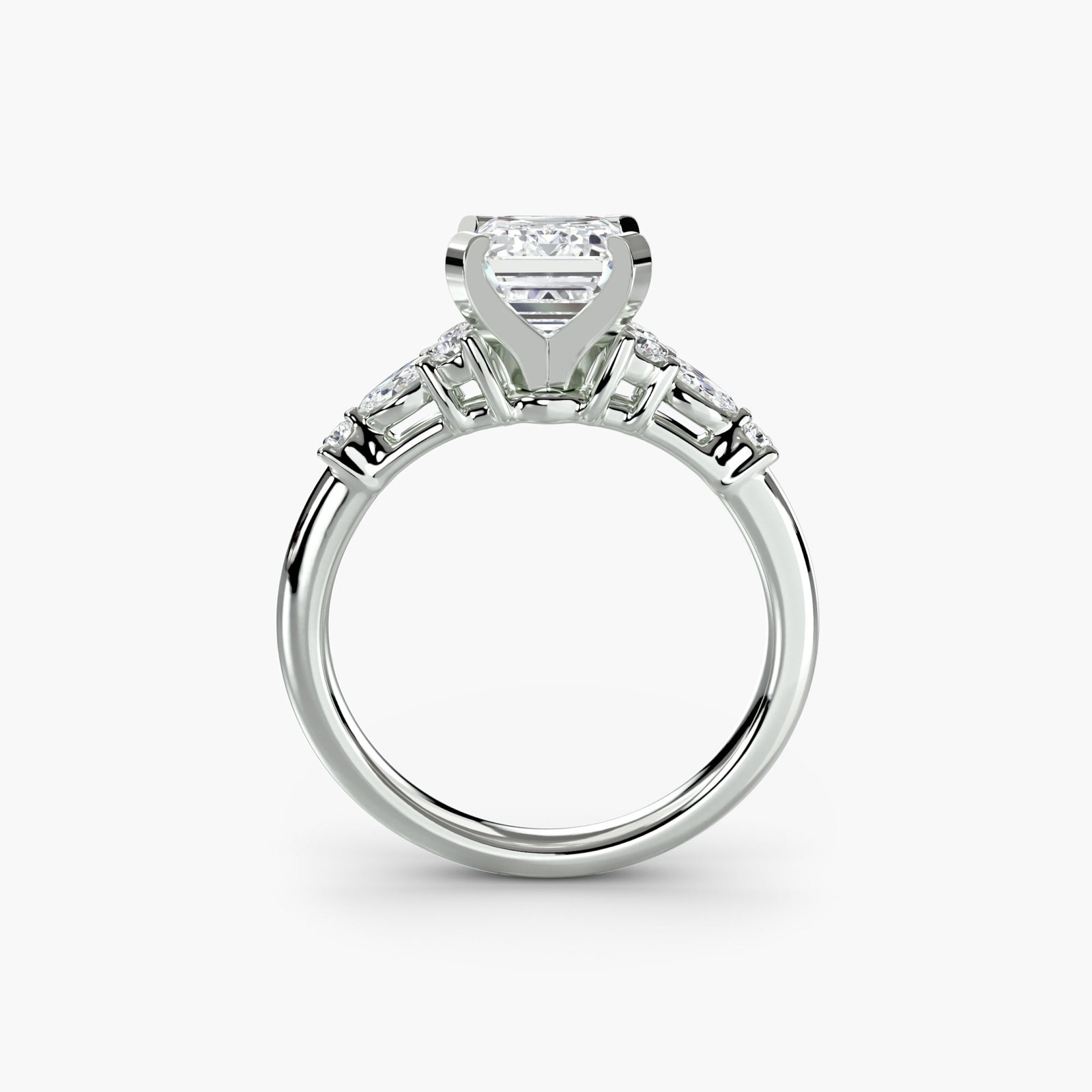 Side Stone Emerald 18Kt White Gold Ring Setting: Side Stone Emerald 18Kt White Gold Ring Setting Elevate your style with this stunning 18Kt White Gold ring setting, featuring eight side stones that add a touch of sophistication to any outfit. The ri