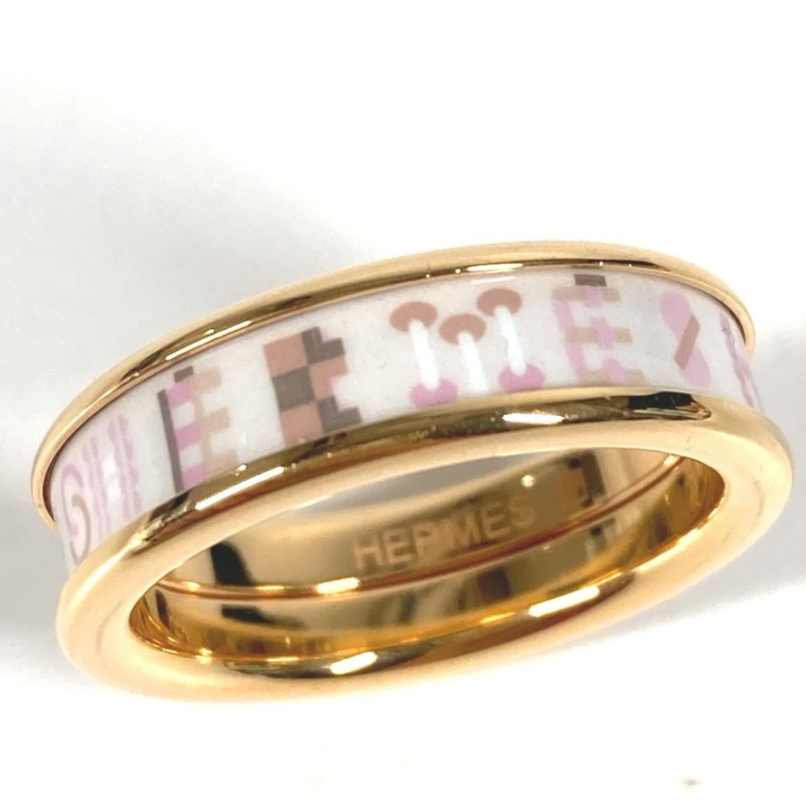 Hermes Band Ring Metal: Hermes Band Ring Metal The Hermes Band Ring Metal boasts a sleek and sophisticated design, available in gold, pink, and white hues. Made from high-quality metal, this casual band ring features a
