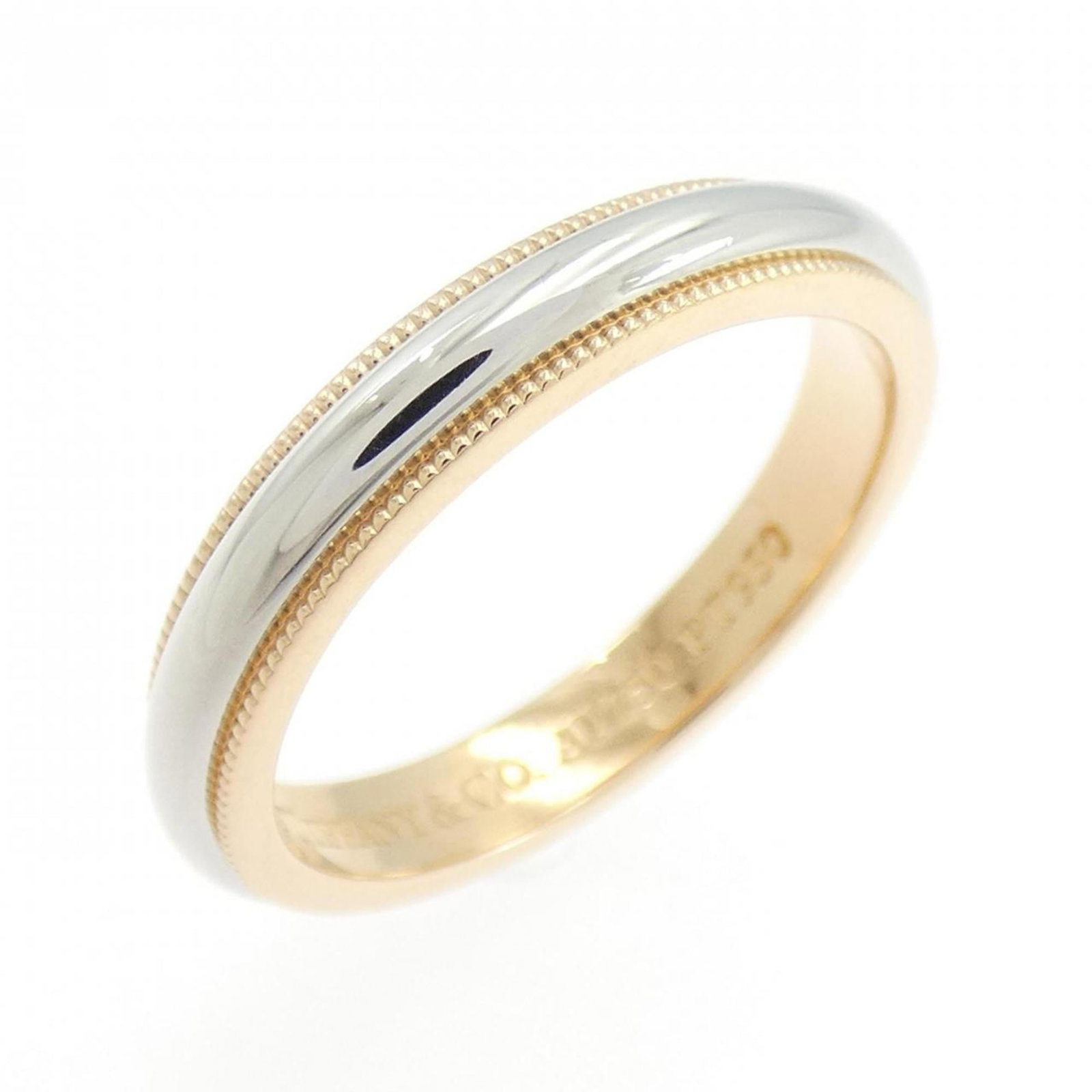 Tiffany Band Ring Pink Gold (18K), Platinum 950: Tiffany Band Ring Pink Gold (18K), Platinum 950 Pink Gold (18K) and Platinum 950 combine in this elegant Tiffany band ring. The ring has some scratches and dirt, but remains in very good condition wit