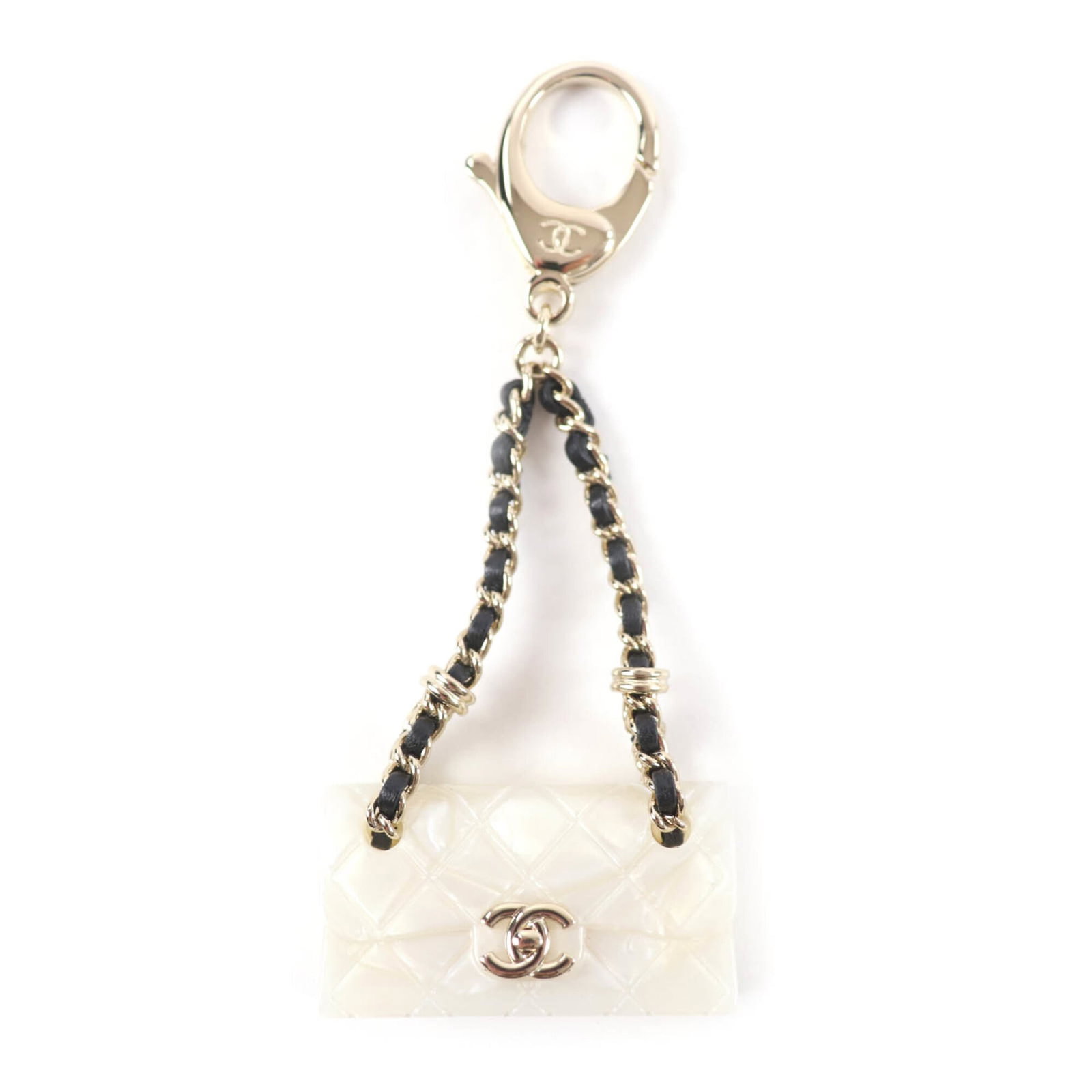 Chanel Handbag Charm: Chanel Handbag Charm White Chanel Handbag Charm in Mint Condition. This like new charm measures 100mm x 40mm and features a crisp white finish. In mint condition, this small accessory adds a touch of 