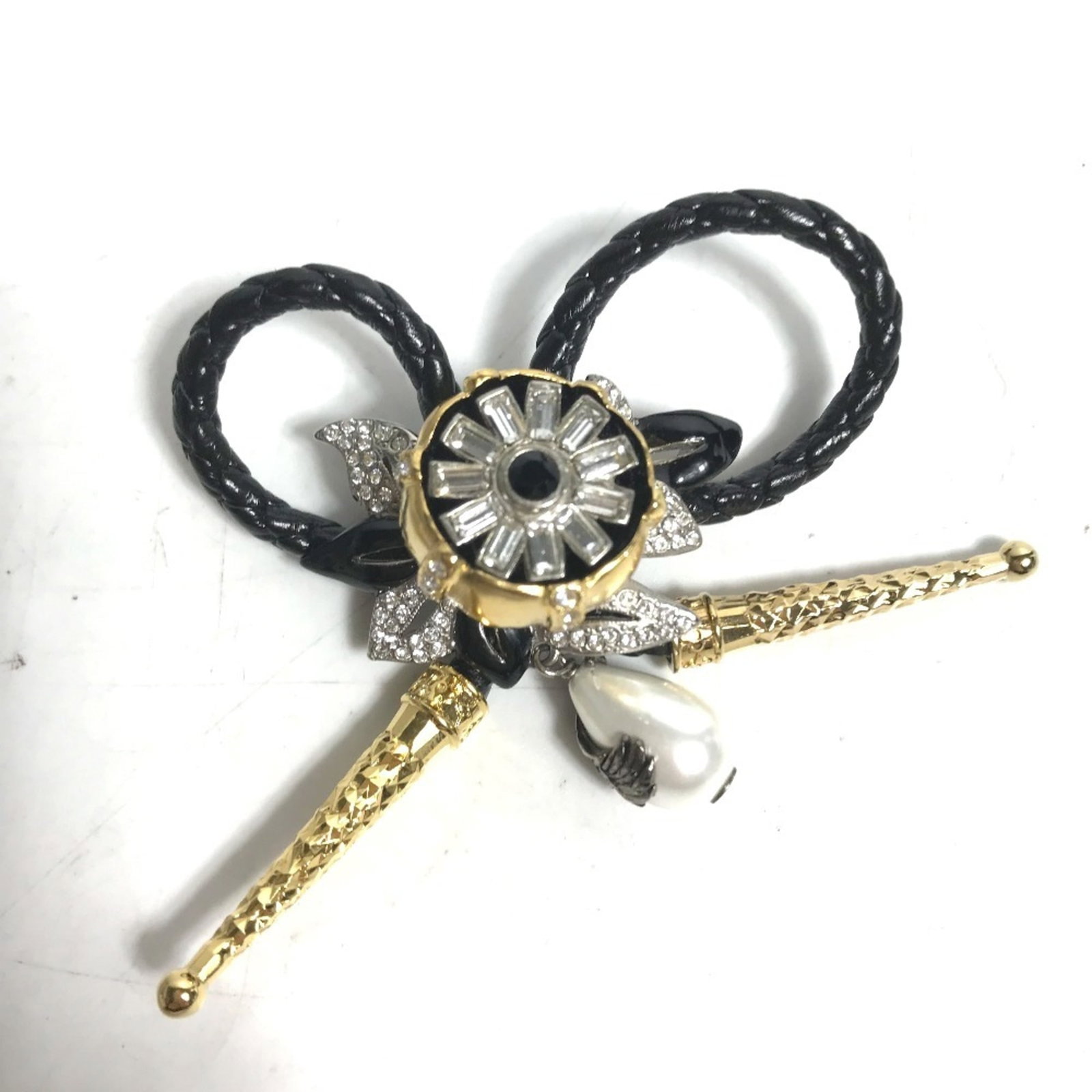 Louis Vuitton Brooch Leather, Metal: Louis Vuitton Brooch Leather, Metal This Louis Vuitton brooch features a striking combination of black leather and metal, adorned with rhinestones. Measuring 7cm x 6cm, it boasts a classic design that