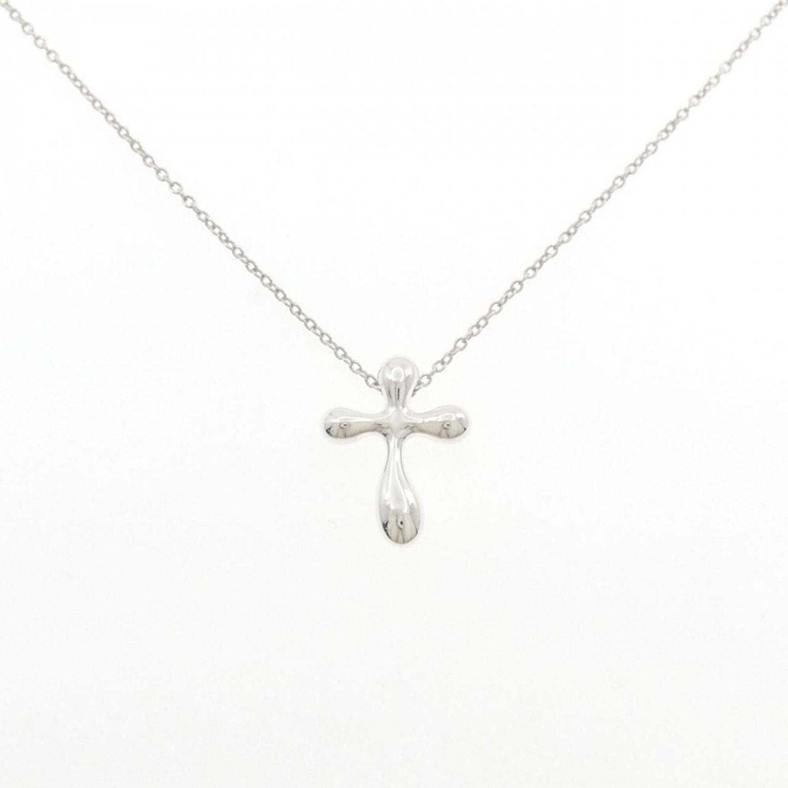 Tiffany Cross Necklace: Tiffany Cross Necklace The Tiffany Cross Necklace boasts elegant silver 925 construction and a striking pendant design. With its 41 cm adjustable neck circumference, this necklace offers a versatile f