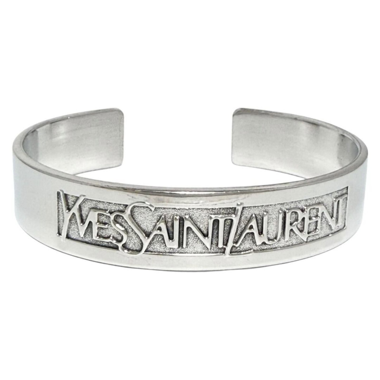 Saint Laurent Bangle Silver 925: Saint Laurent Bangle Silver 925 Silver 925 bangle from Saint Laurent, featuring a classic design with a few traces of usage visible. The bangle has some scratches and dirt, but remains in very good co