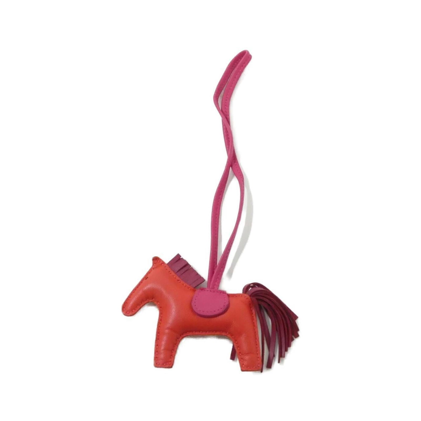 Hermes Handbag Charm Agneau Milo: Hermes Handbag Charm Agneau Milo Agneau Milo Handbag Charm from Hermes boasts a striking red hue, adding a pop of color to any accessory. This used charm measures 75.00mm x 85.00mm and features some