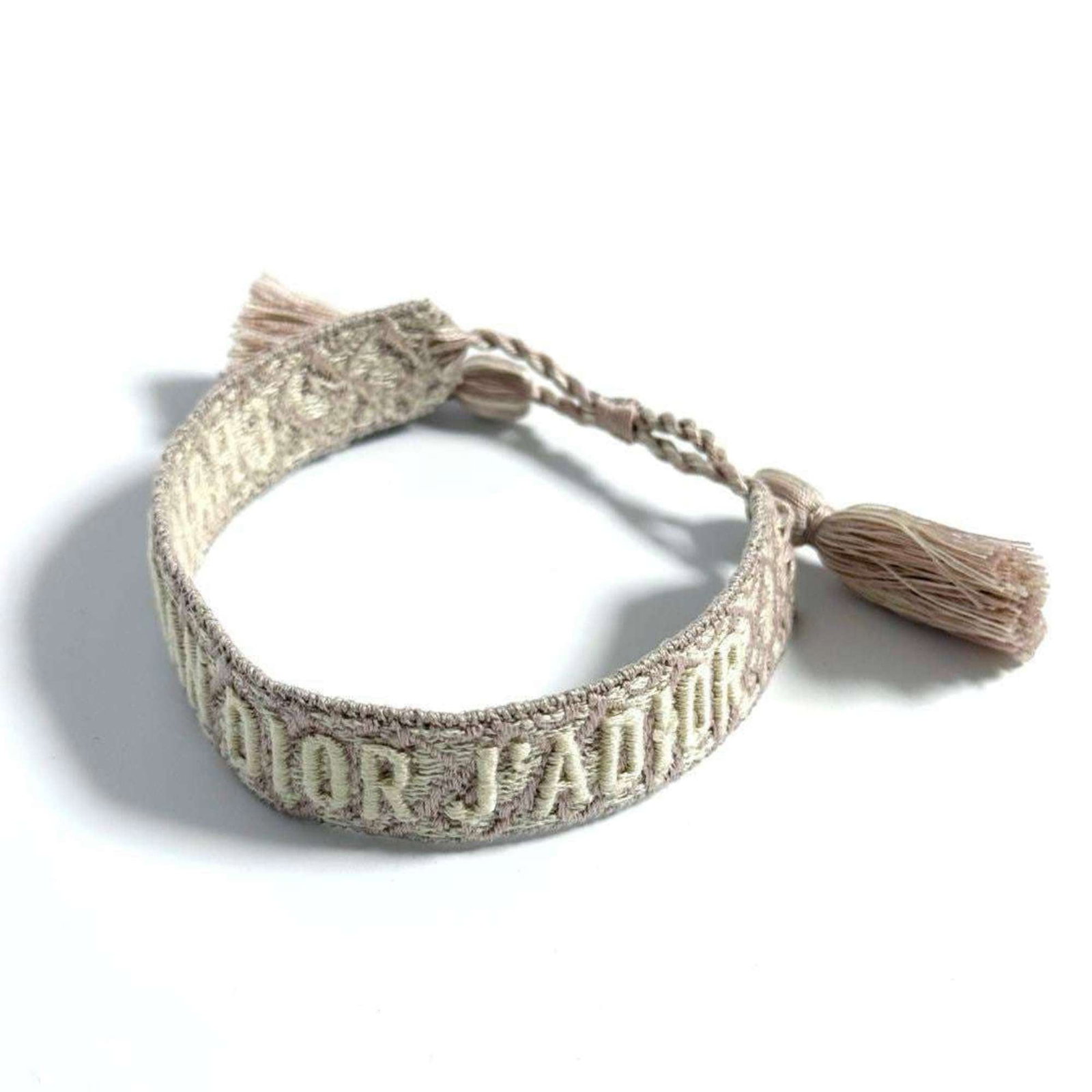 Christian Dior Charm Bracelet Canvas: Christian Dior Charm Bracelet Canvas Canvas charm bracelet from Christian Dior, featuring canvas material and adjustable length of 15cm-23cm. This opened item has not been used and showcases the