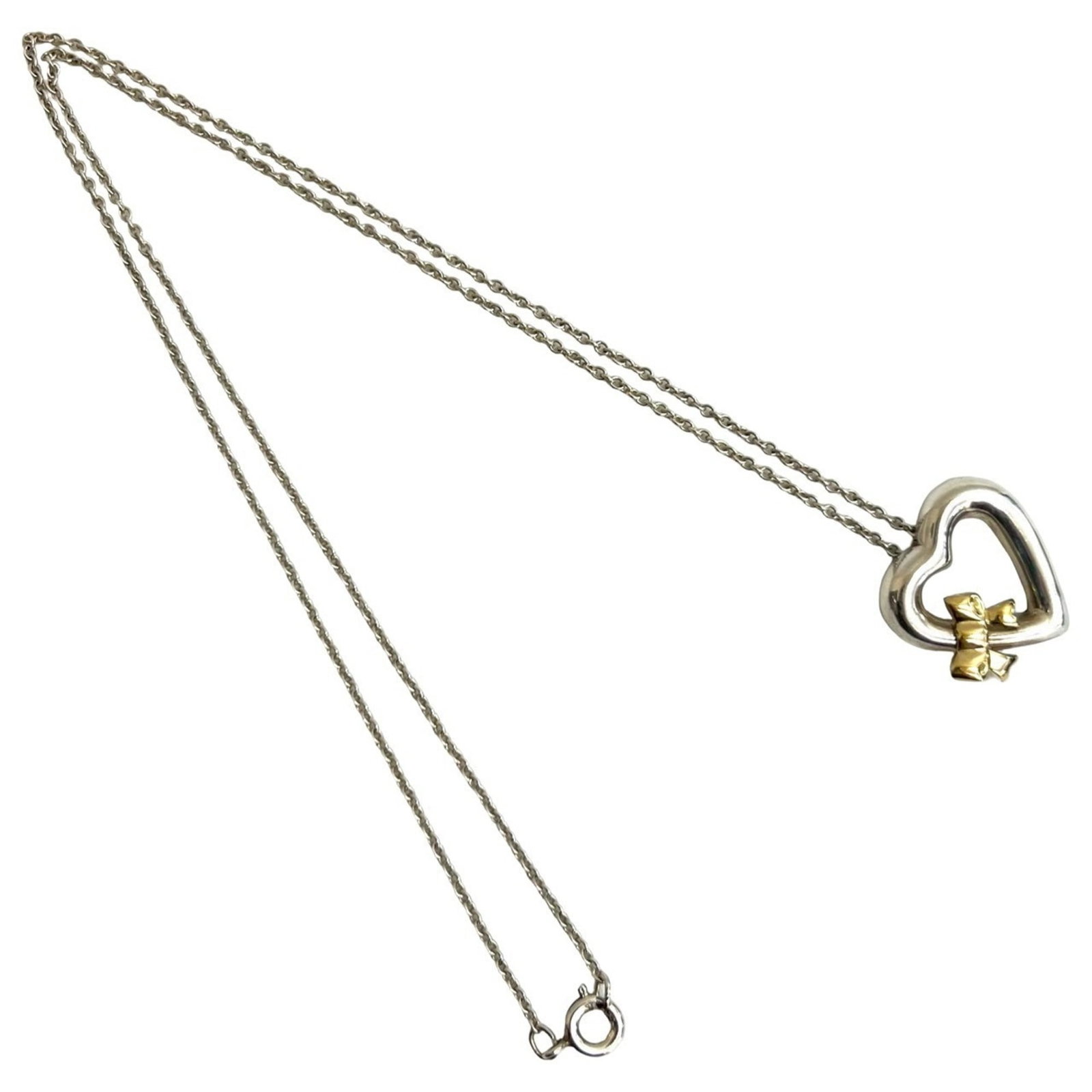 TIFFANY & Co. Tiffany Heart Ribbon Necklace in 925 Sterling Silver and 18K Yellow Gold, 1134a: TIFFANY & Co. Tiffany Heart Ribbon Necklace in 925 Sterling Silver and 18K Yellow Gold, 1134a The Tiffany Heart Ribbon Necklace in 925 Sterling Silver and 18K Yellow Gold features a striking design
