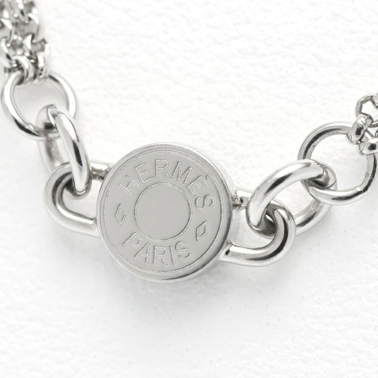 Hermes Charnire PM Serie Necklace Metal Leather 40 cm RI-159859: Hermes Charnire PM Serie Necklace Metal Leather 40 cm RI-159859 The Hermes Charnire PM Serie Necklace in silver features metal and leather accents, measuring 40 cm in circumference. This necklace has
