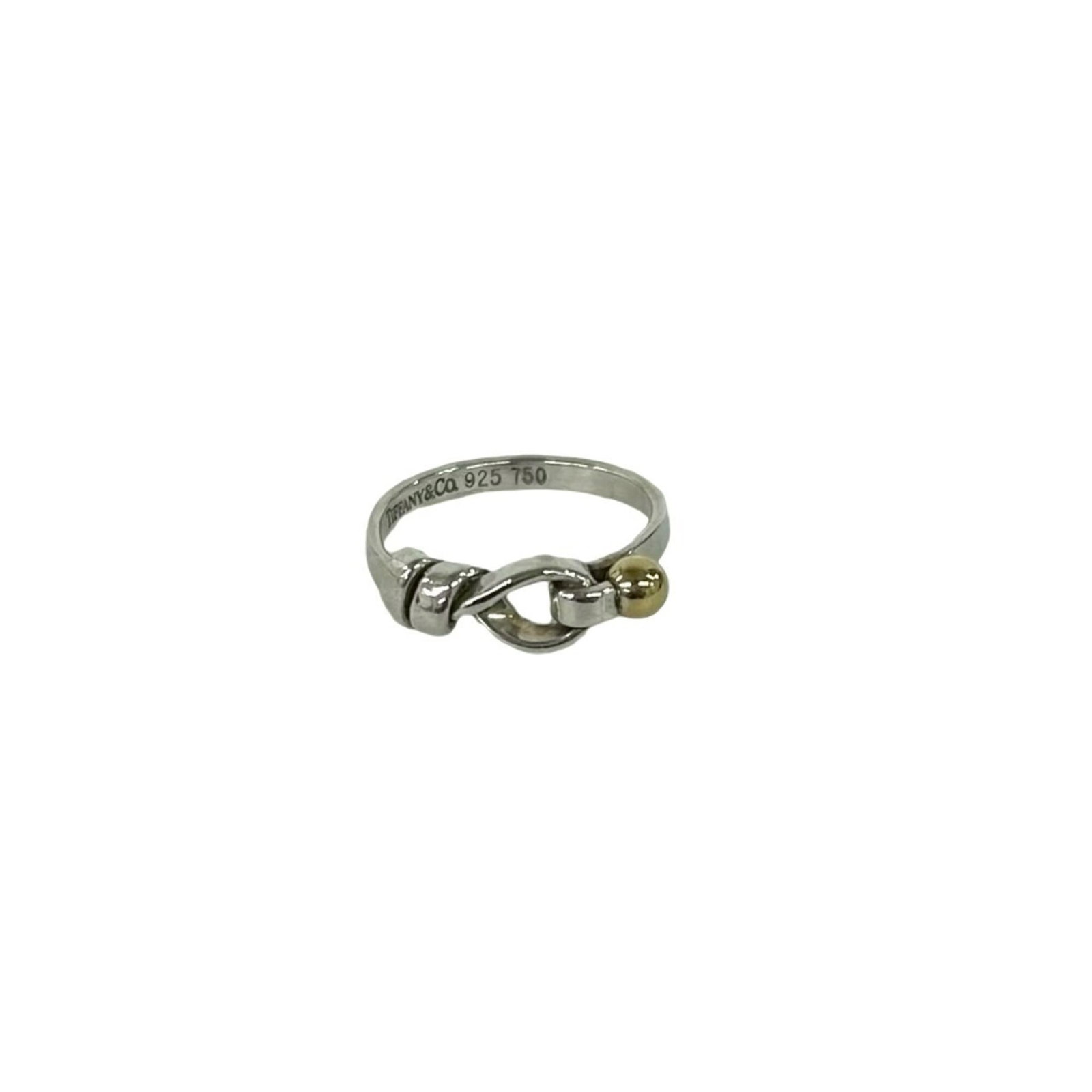 Tiffany Band Ring Silver 925, Yellow Gold (18K): Tiffany Band Ring Silver 925, Yellow Gold (18K) Silver 925 and yellow gold (18K) combine in this Tiffany band ring, offering a touch of luxury to any outfit. With its classic design and high-quality