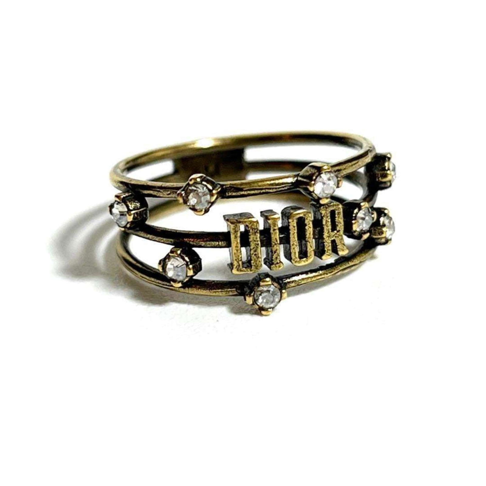 Christian Dior Band Ring Metal, Rhinestone: Christian Dior Band Ring Metal, Rhinestone Used Christian Dior Band Ring Metal Rhinestone in very good condition. This ring features metal and rhinestone construction, bearing a few traces of usage wi