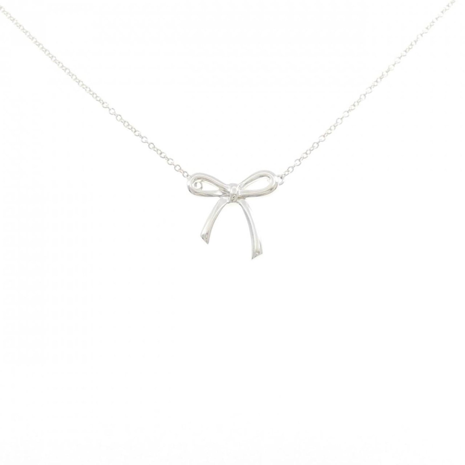 Tiffany Bow Necklace: Tiffany Bow Necklace Tiffany's iconic Bow Necklace boasts elegant simplicity with its sterling silver 925 material and classic pendant design. Measuring 14.5mm x 14.6mm, this necklace features a timel