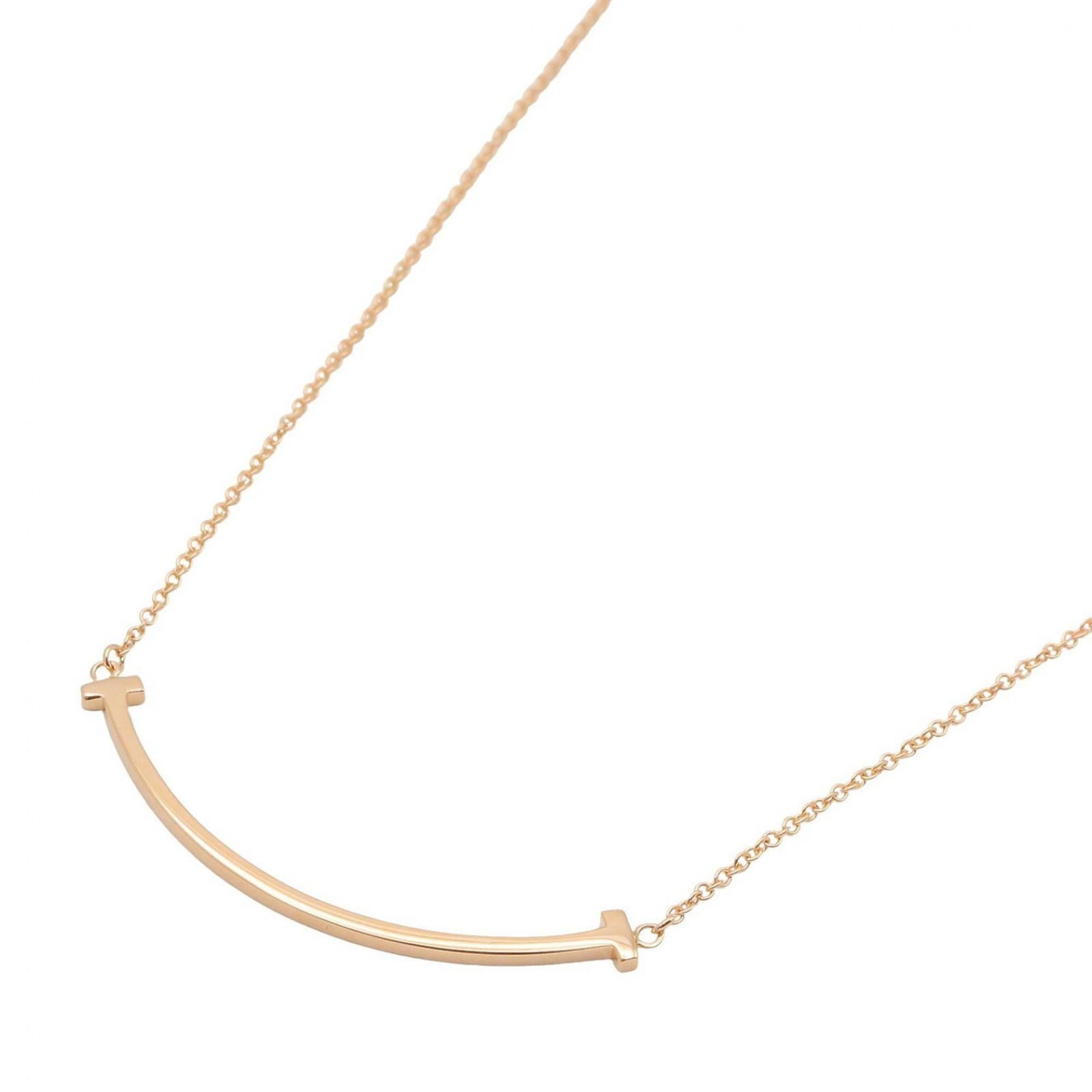 Tiffany & Co. T Smile Necklace, Small 18K Pink Gold (PG), Men's Women's, Tone, 60011678: Tiffany & Co. T Smile Necklace, Small 18K Pink Gold (PG), Men's Women's, Tone, 60011678 Tiffany & Co.'s iconic T Smile Necklace in small 18K pink gold is a timeless piece of elegance. With its classic