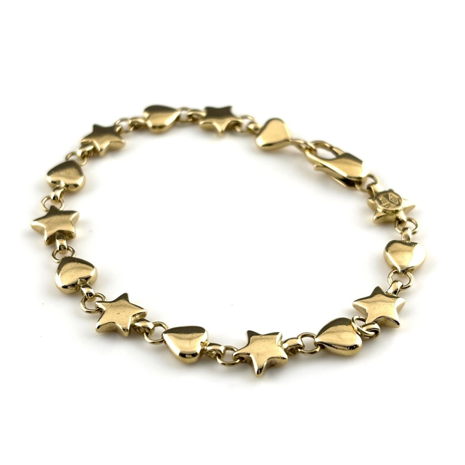 Tiffany Charm Bracelet: Tiffany Charm Bracelet Yellow Gold Tiffany Charm Bracelet. This used charm bracelet features a yellow gold finish and measures 17cm in length. With traces of usage and minor scratches, it remains gene