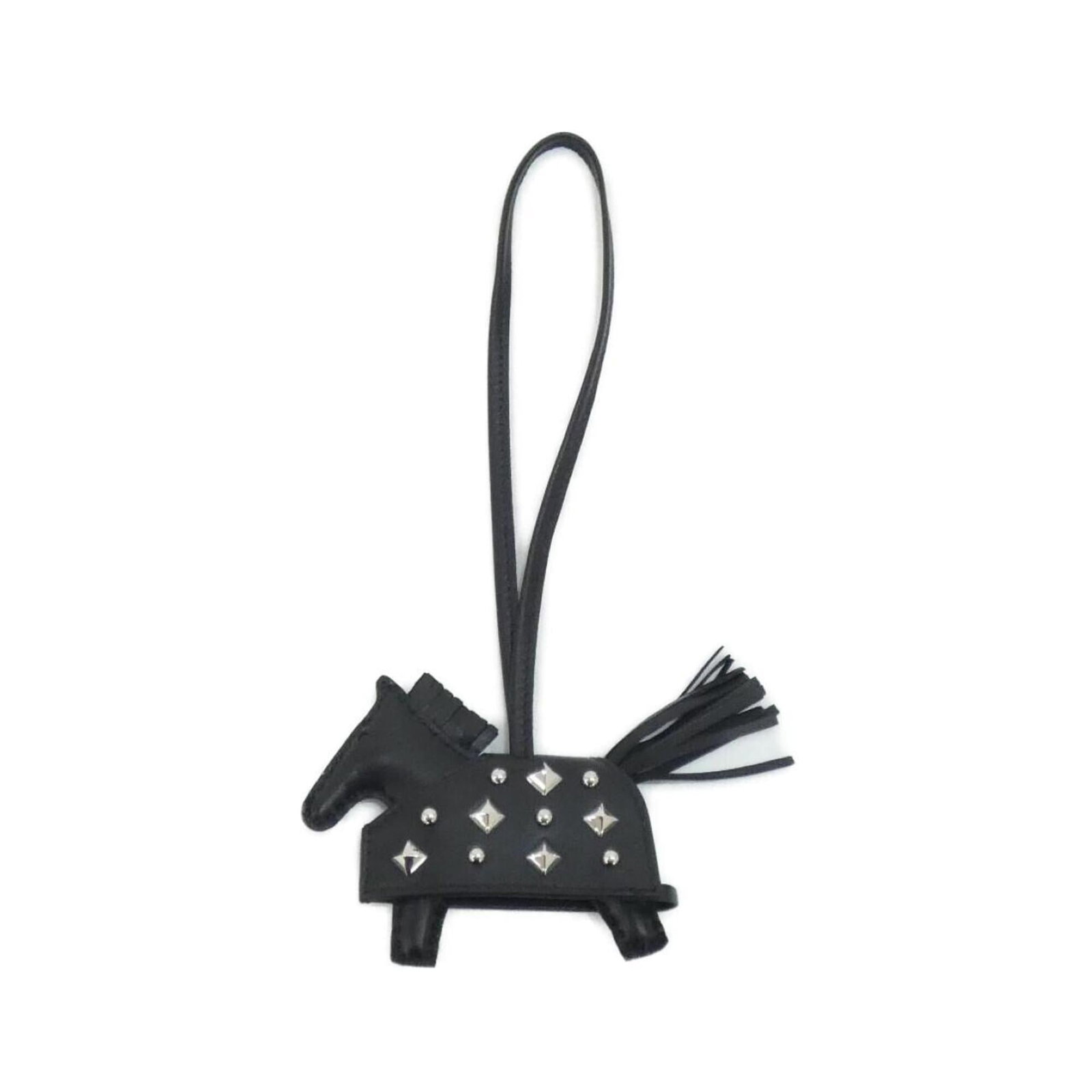 Hermes Handbag Charm Agneau Milo: Hermes Handbag Charm Agneau Milo Agneau Milo Handbag Charm from Hermes features a sleek black design with subtle scratches and minor dirt marks. Made from high-quality Agneau Milo material, this charm