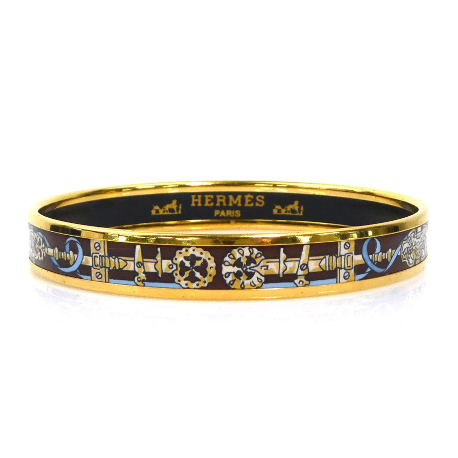 Hermes Bangle Enamel, Metal: Hermes Bangle Enamel, Metal The Hermes bangle boasts an elegant combination of enamel and metal, with striking blue, brown, and gold hues. With its classic design and timeless appeal, this piece